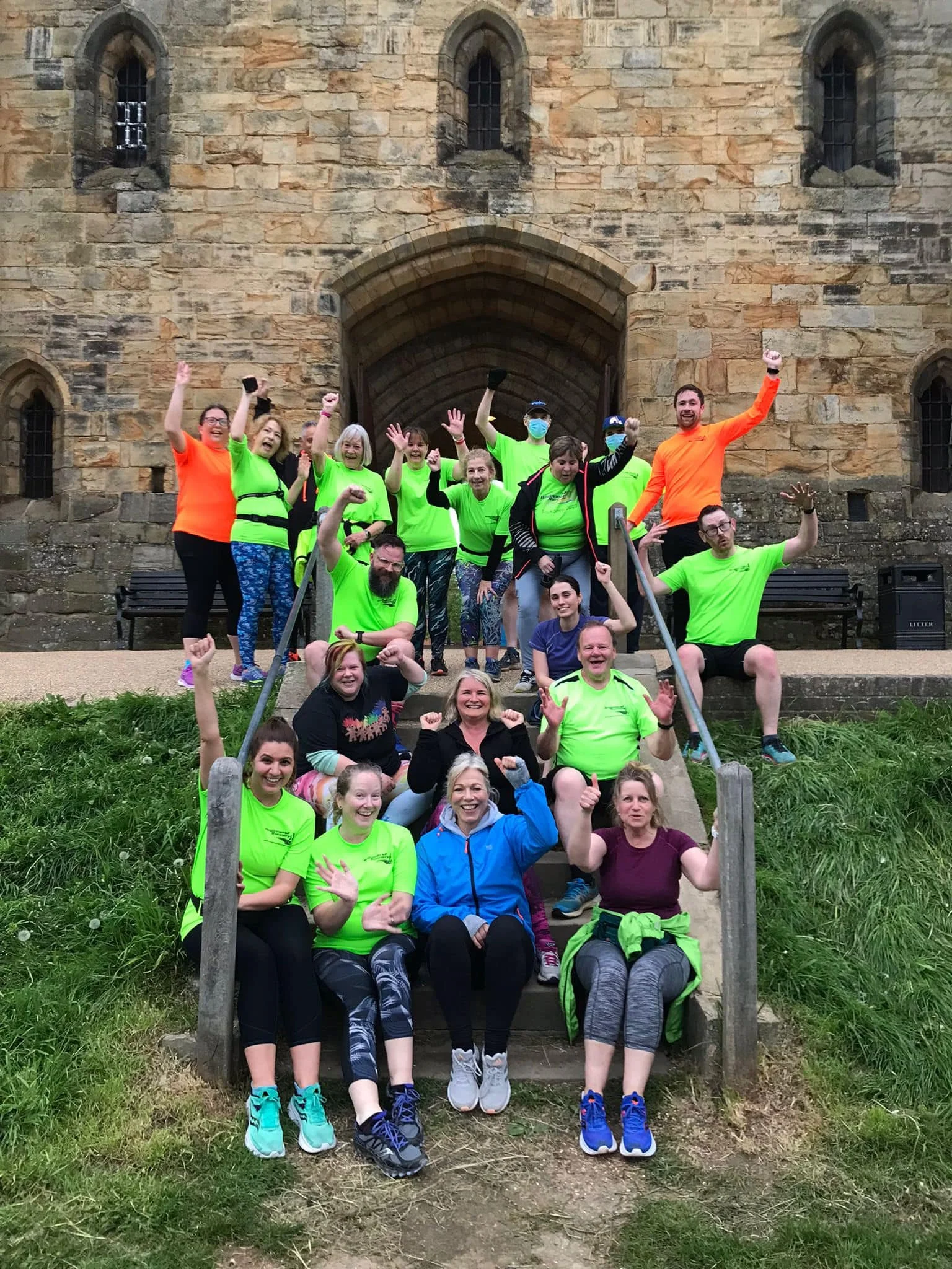 Group of B2R members posing for a photo on stone steps in front of a historic brick building, during a club session.