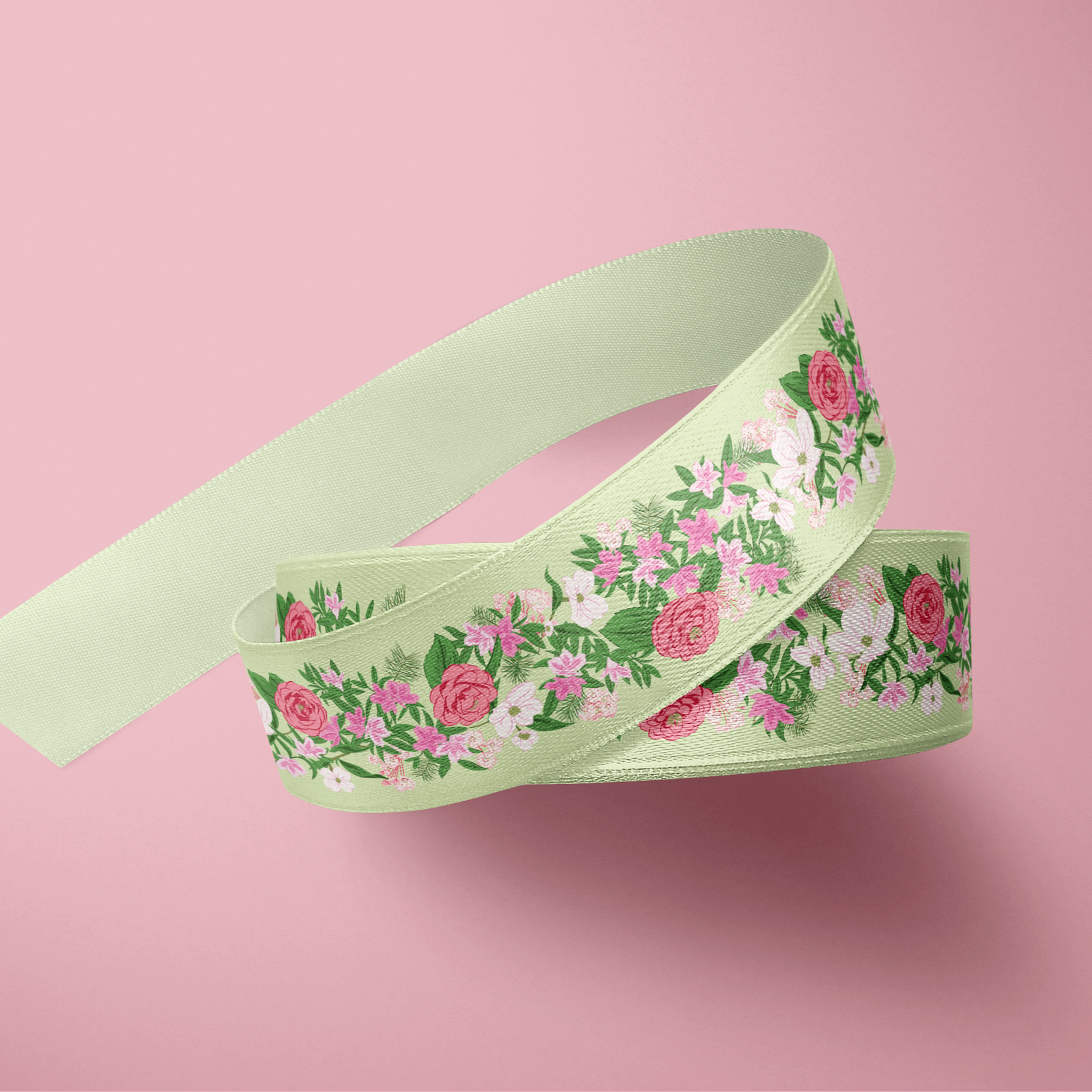 Decorative pale green ribbon featuring a floral garland border design in shades of pink and green, styled against a soft pink background.