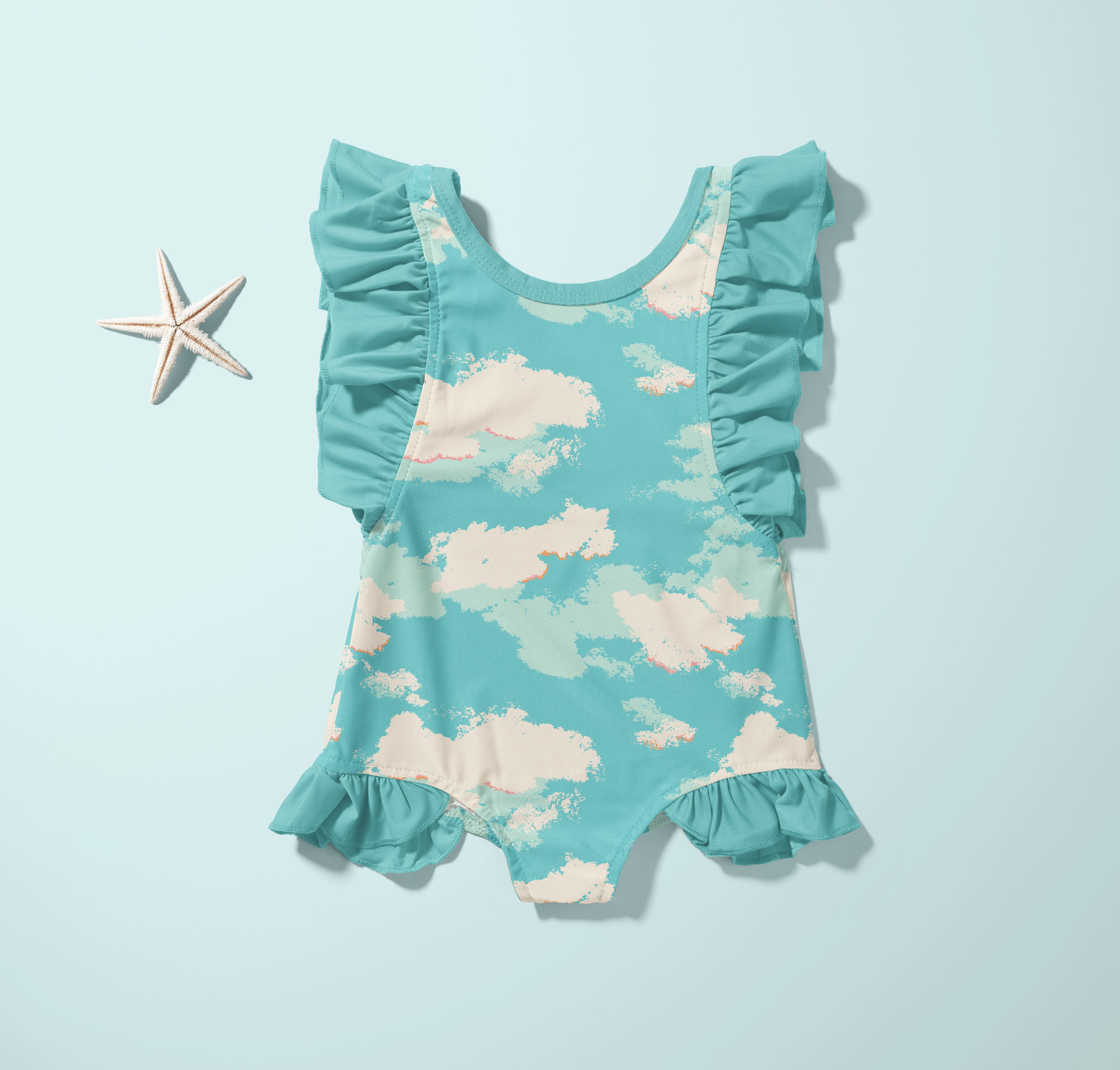 Children’s ruffle swimsuit in aqua blue featuring soft cloud motif surface pattern on a clean pastel background.