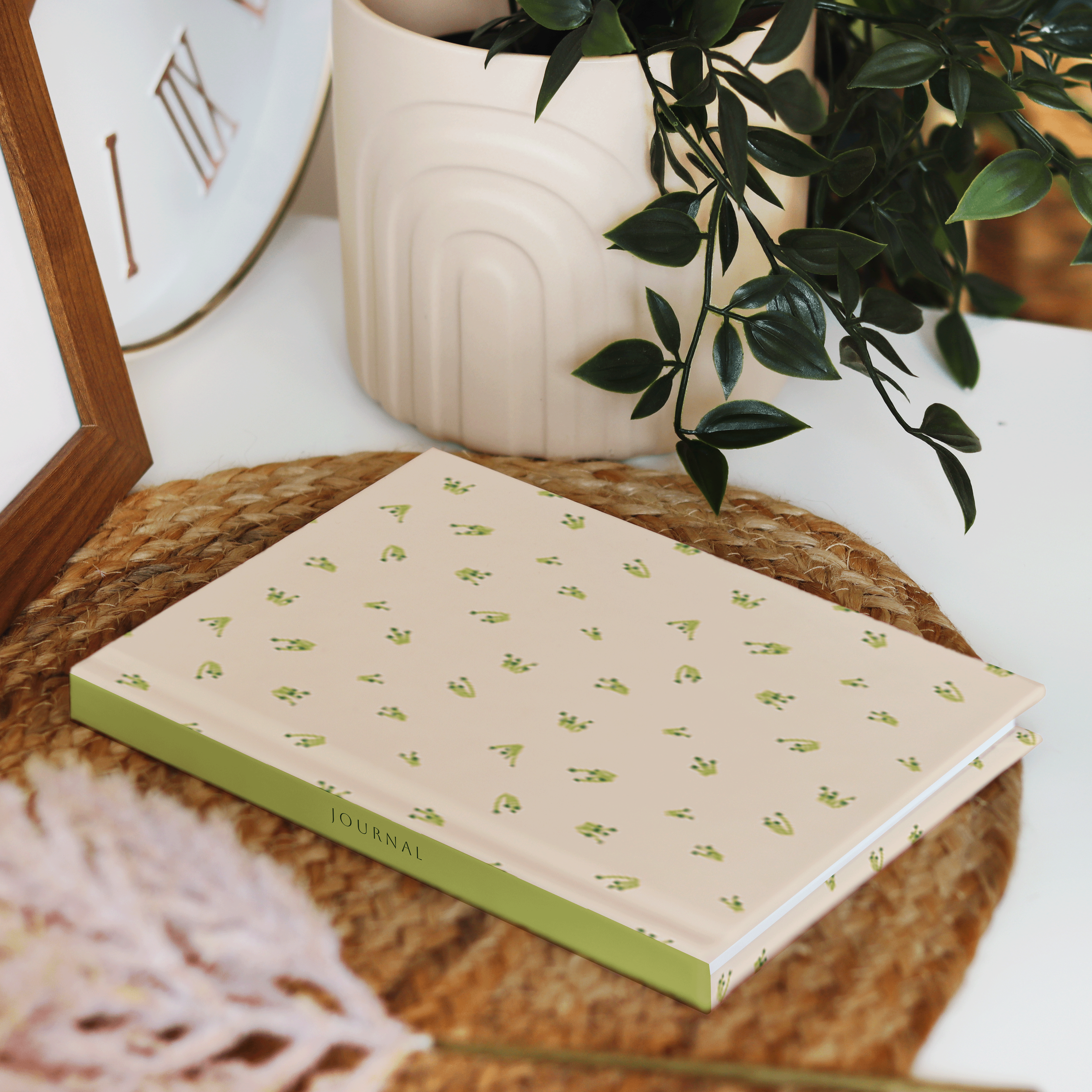 Small-scale botanical surface pattern inspired by early growth and budding floral forms, shown on a journal cover.