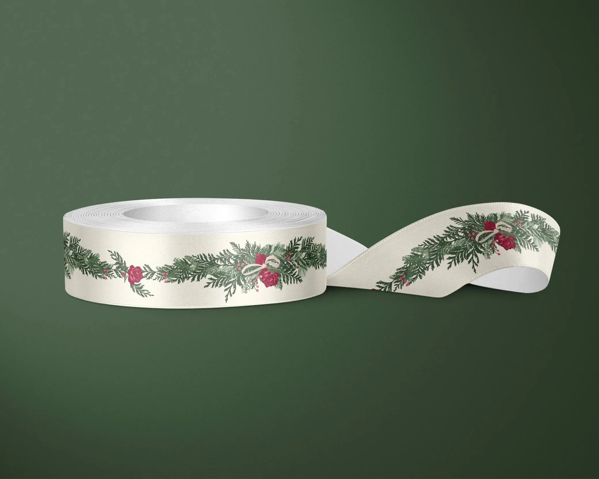 Cream satin ribbon printed with an elegant evergreen garland featuring winter roses, berries, and ribbon bows, displayed on a spool against a deep green background.