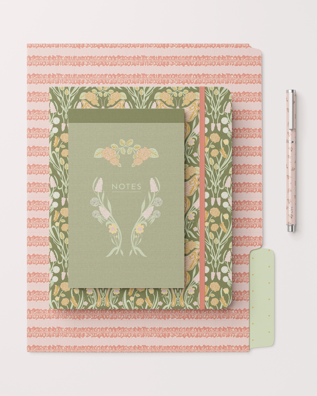 Coordinated stationery set from Tea Garden Daydreams featuring an engineered floral notebook cover, patterned folder, and matching pen in soft green and blush tones.