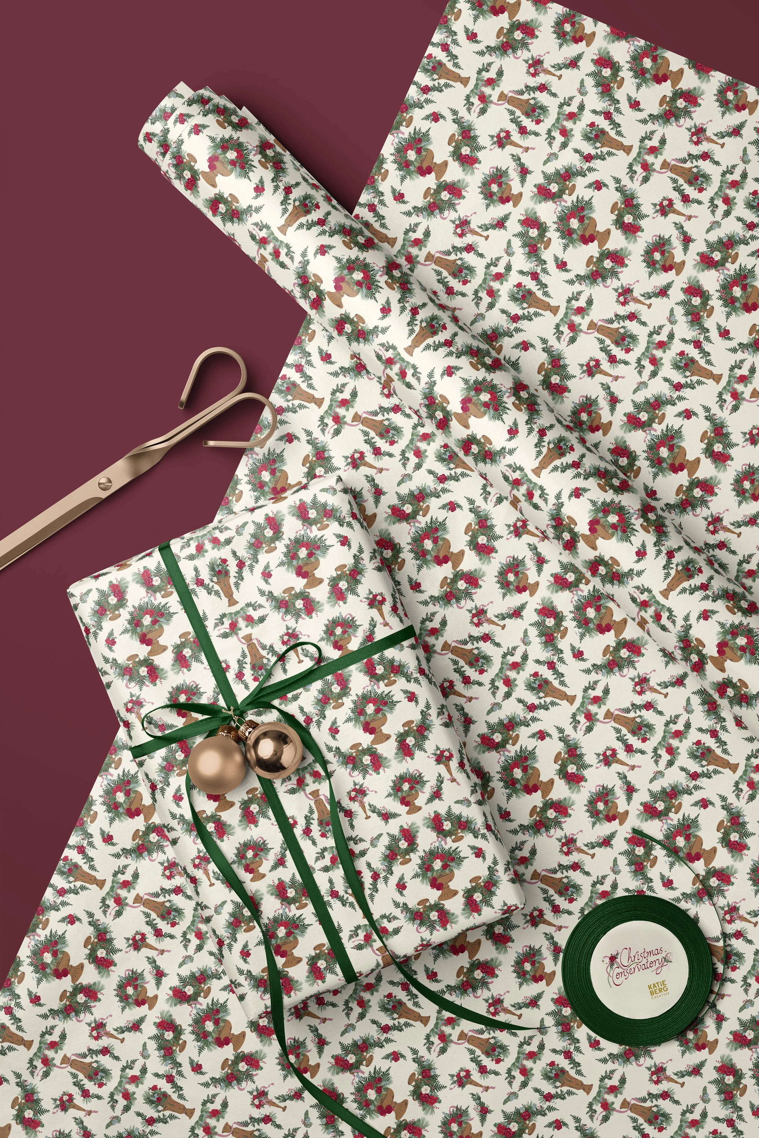 Roll of Christmas wrapping paper printed with elegant winter floral arrangements in antique pedestal vessels