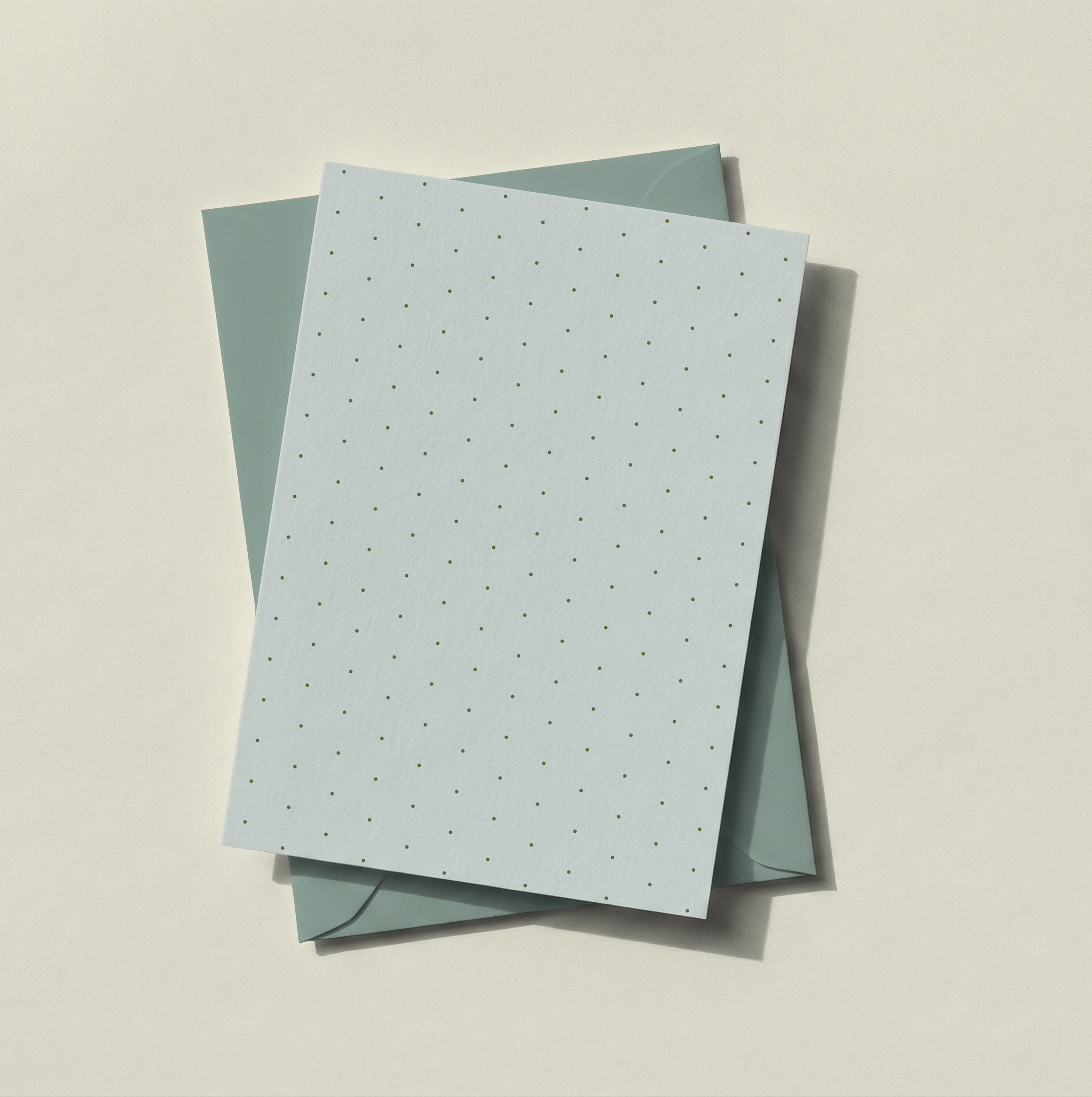 Surface pattern design featuring small-scale polka dots, inspired by light and tailored spring motifs, displayed on stationery.