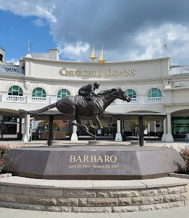Falcon statue in front of Churchill Downs racetrack with a sign honoring Barbaro, a Kentucky Derby winner, from April 28, 2006, to January 29, 2007.