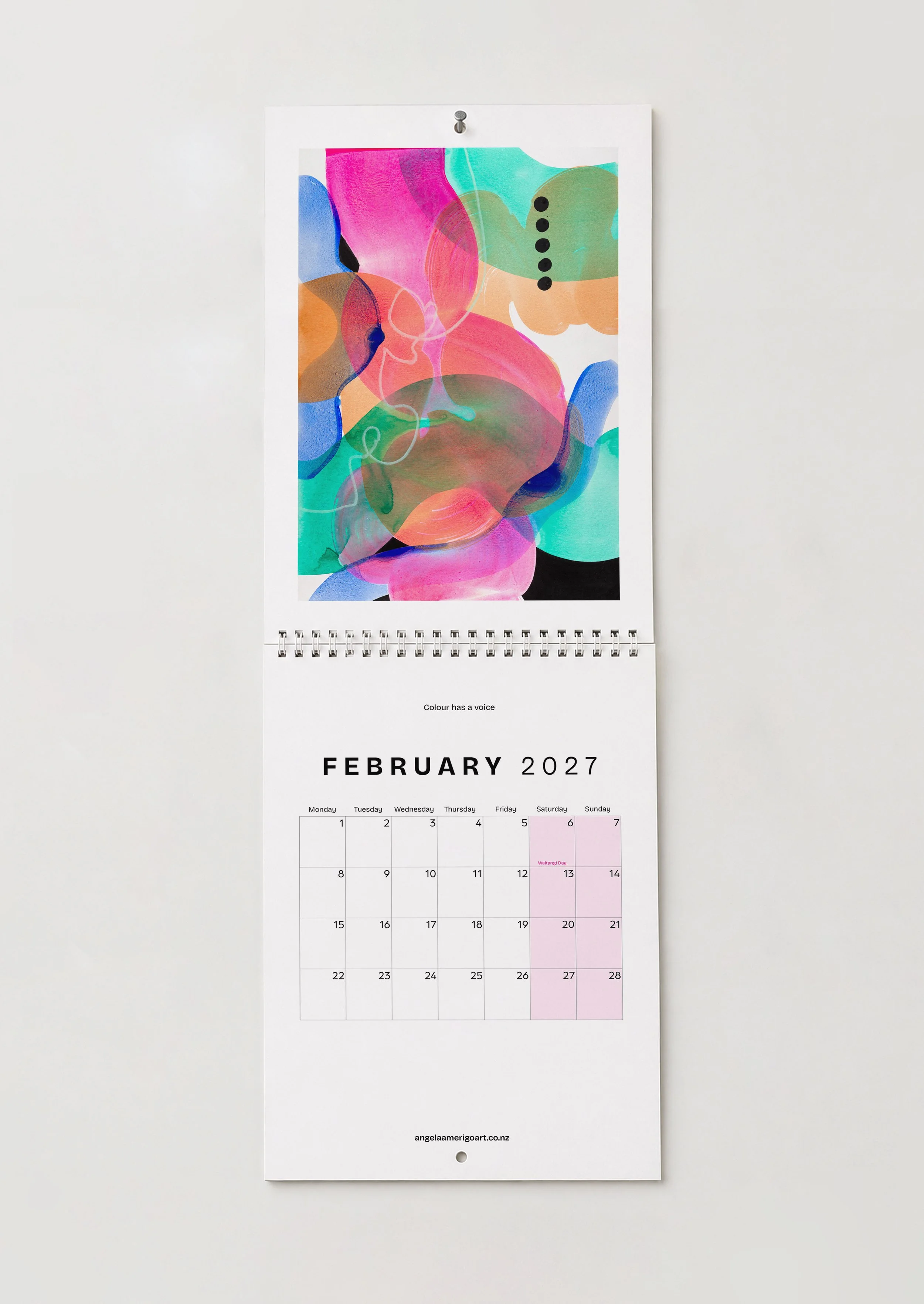February — "Colour has a voice": February wall calendar page featuring layered pink, teal and orange abstract shapes, Colour has a voice