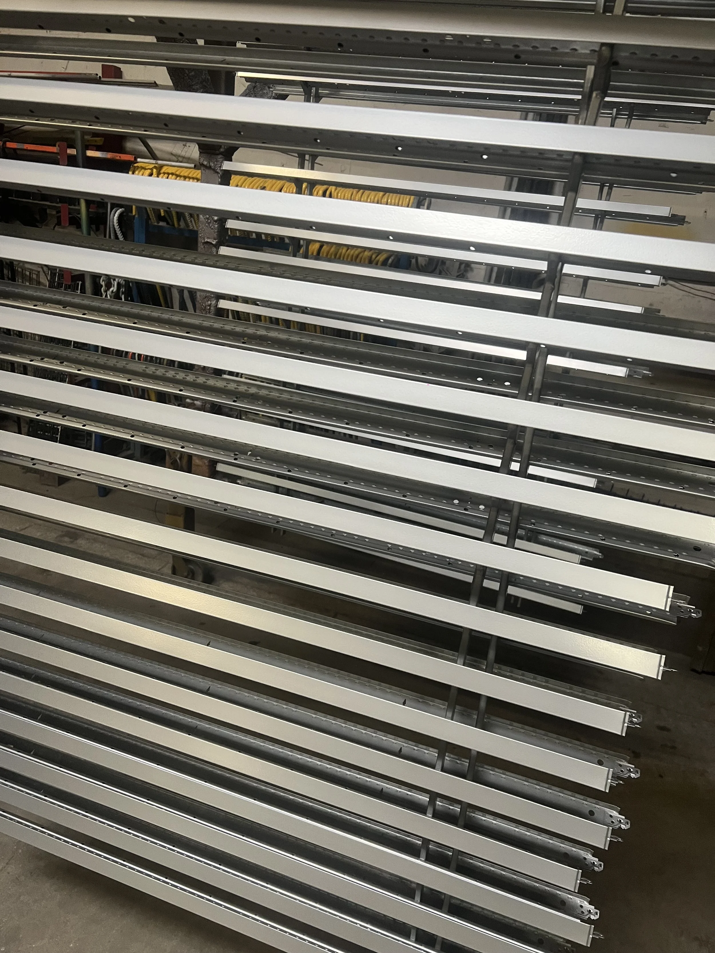 Metal shelving units on wheels in a warehouse.