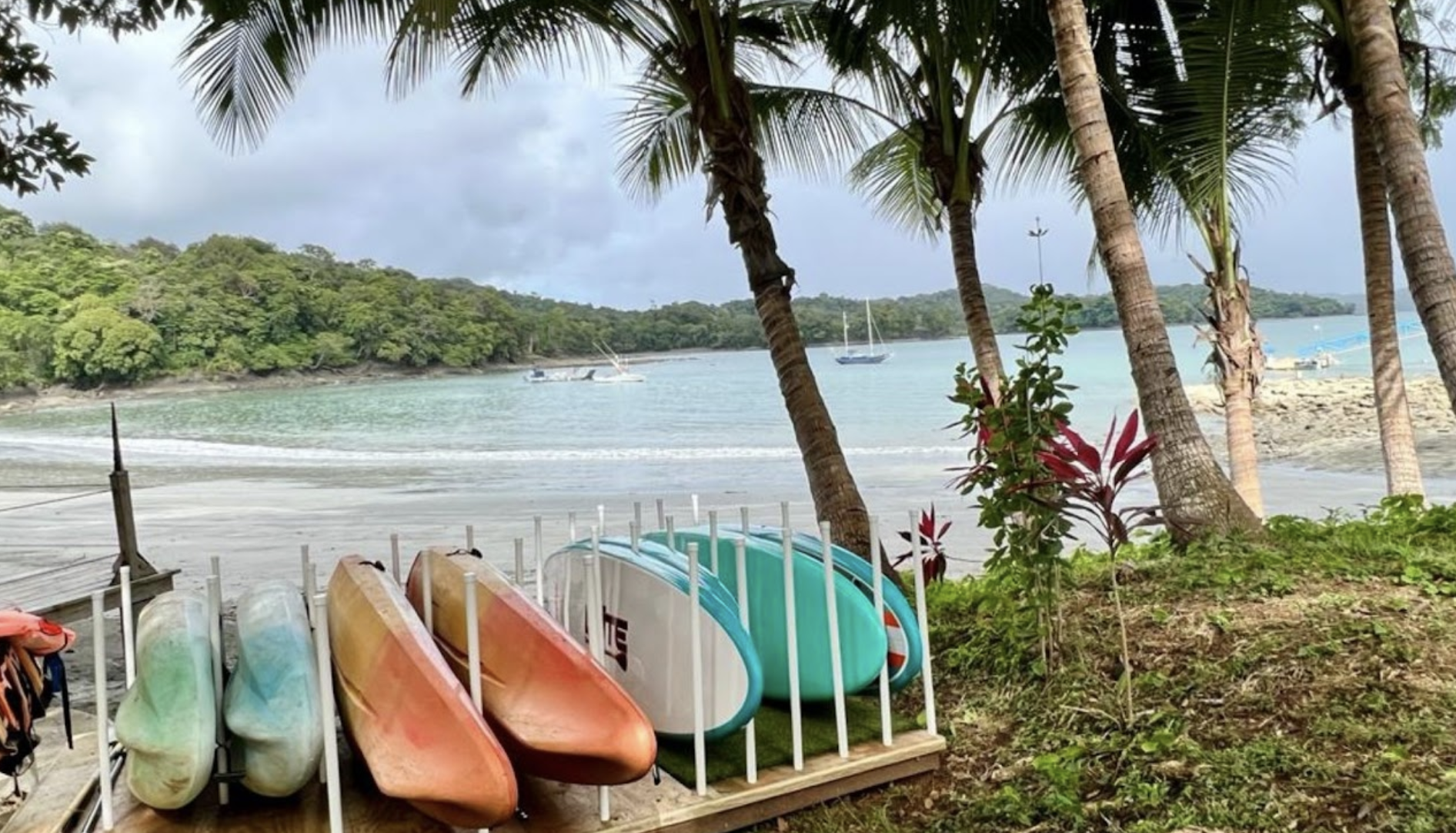 ST Kayaks on beach by bay.png