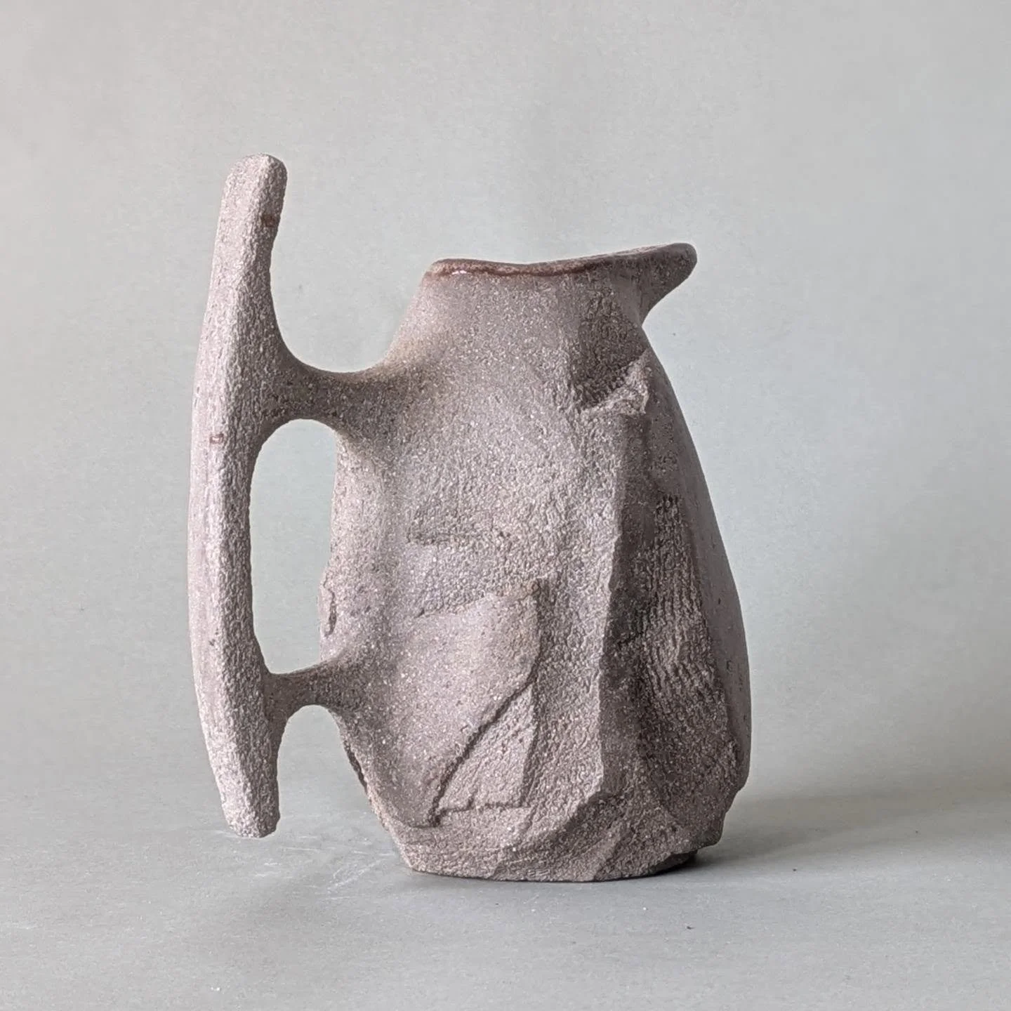 Groggy carved pitcher, does it resemble a penguin with a katana? 
#ceramics #pitcher