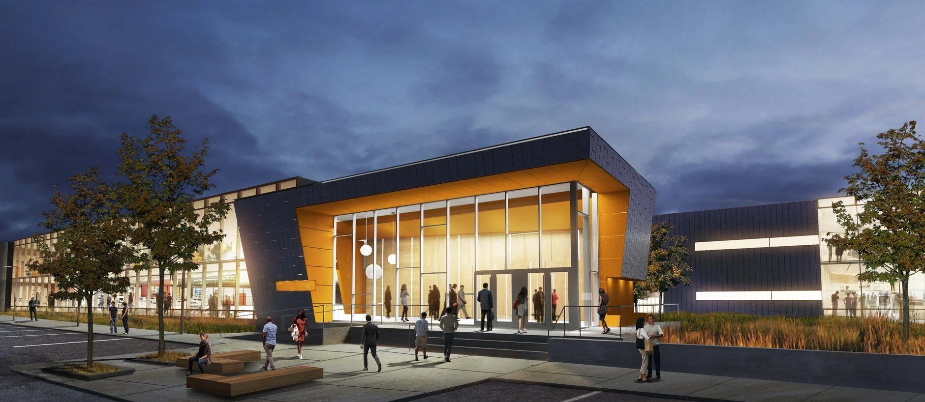 Modern architectural building at dusk with large glass entrance, yellow accents, and people entering and exiting, surrounded by trees and seating areas.