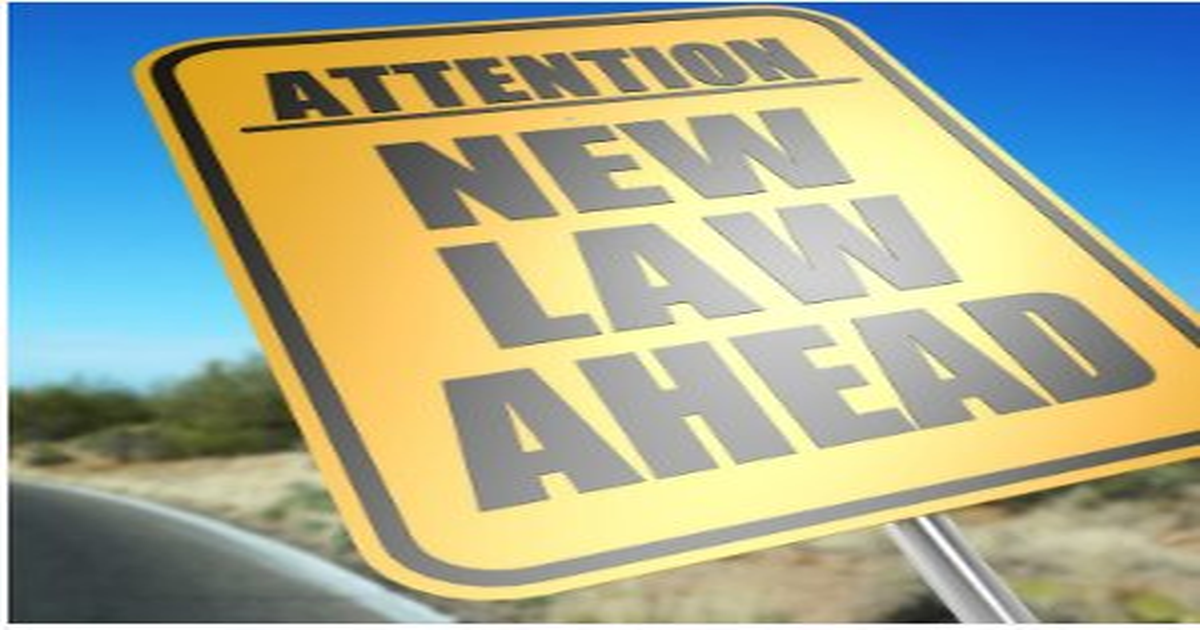 Yellow road sign reading "Attention New Law Ahead" symbolizing new California laws affecting rental property management