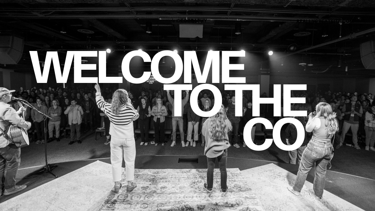 A church or event gathering with three women on stage leading worship music, with a large crowd in front. The text "WELCOME TO THE CO" is overlaid on the image.