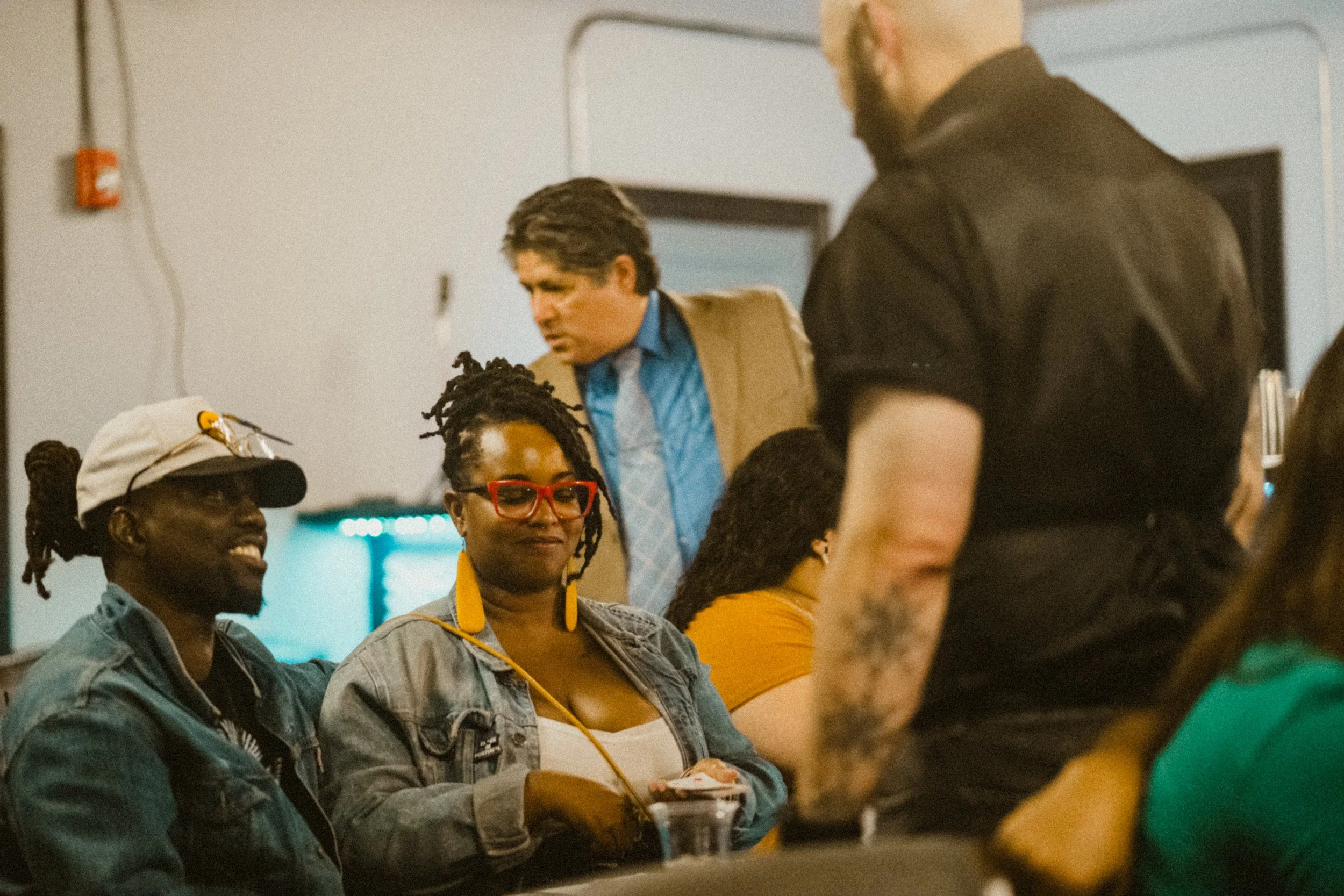 Group of people watching a magic trick indoors.