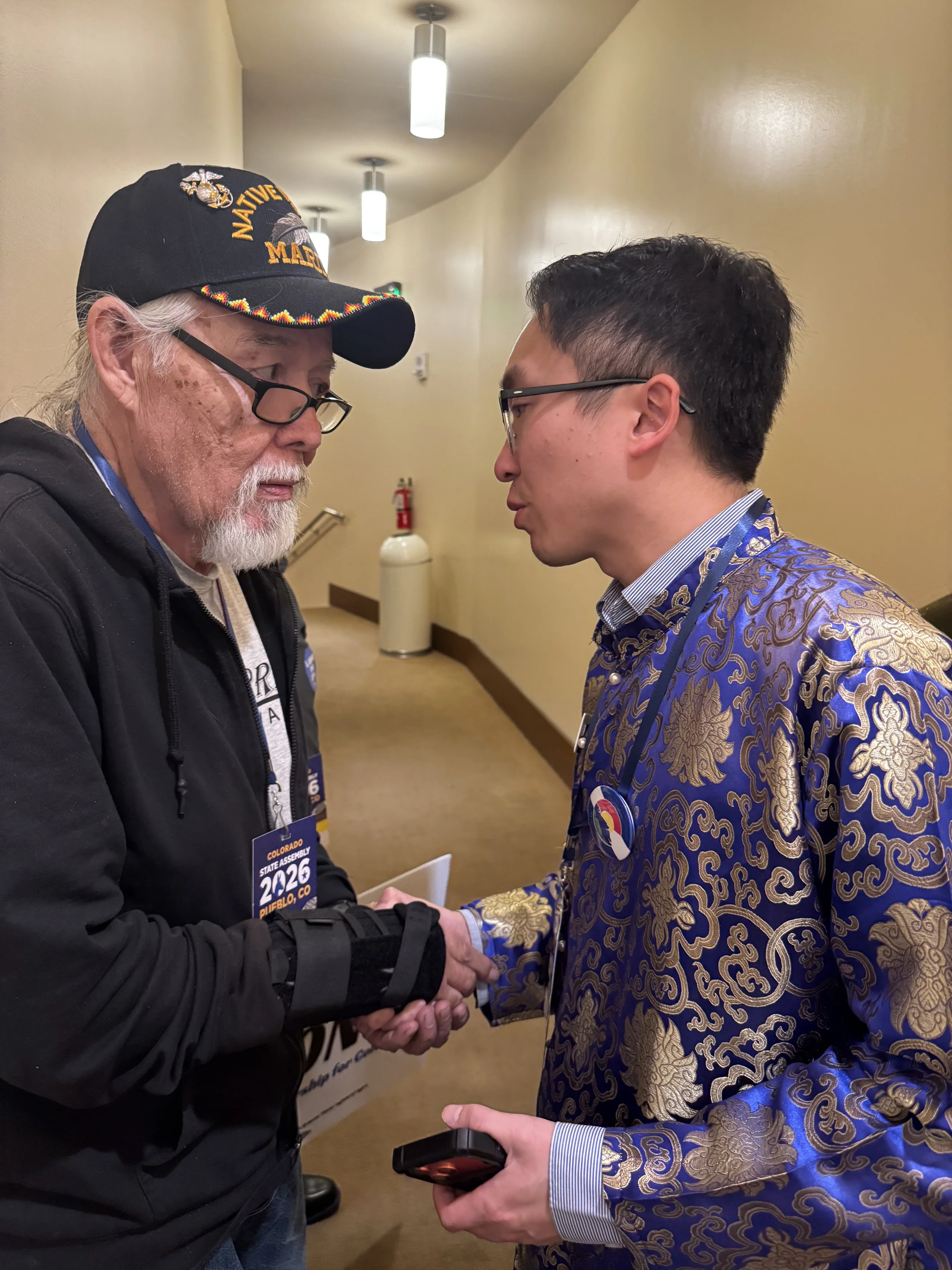 Representative Ngyuen shaking hands with a person at an event.webp