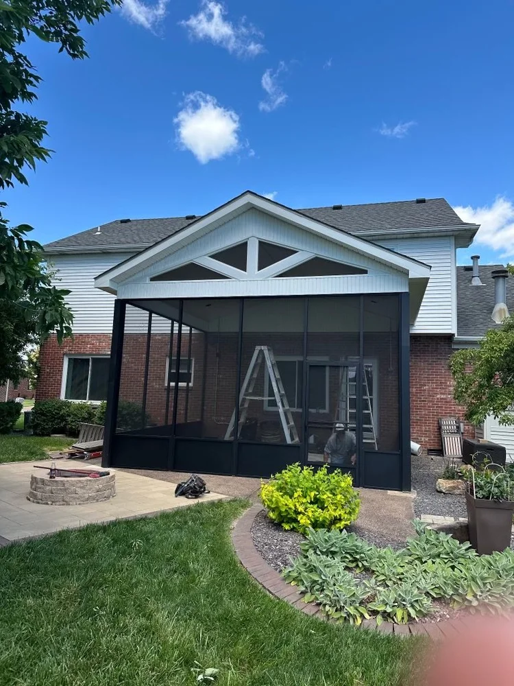 Screen room addition with black framing built by Tenbarge Exteriors