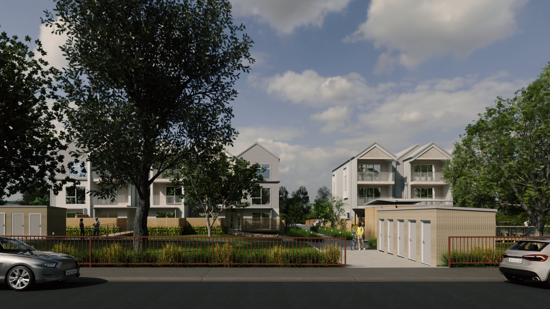 Street view of townhouse development with garage block, landscaping and pedestrian access