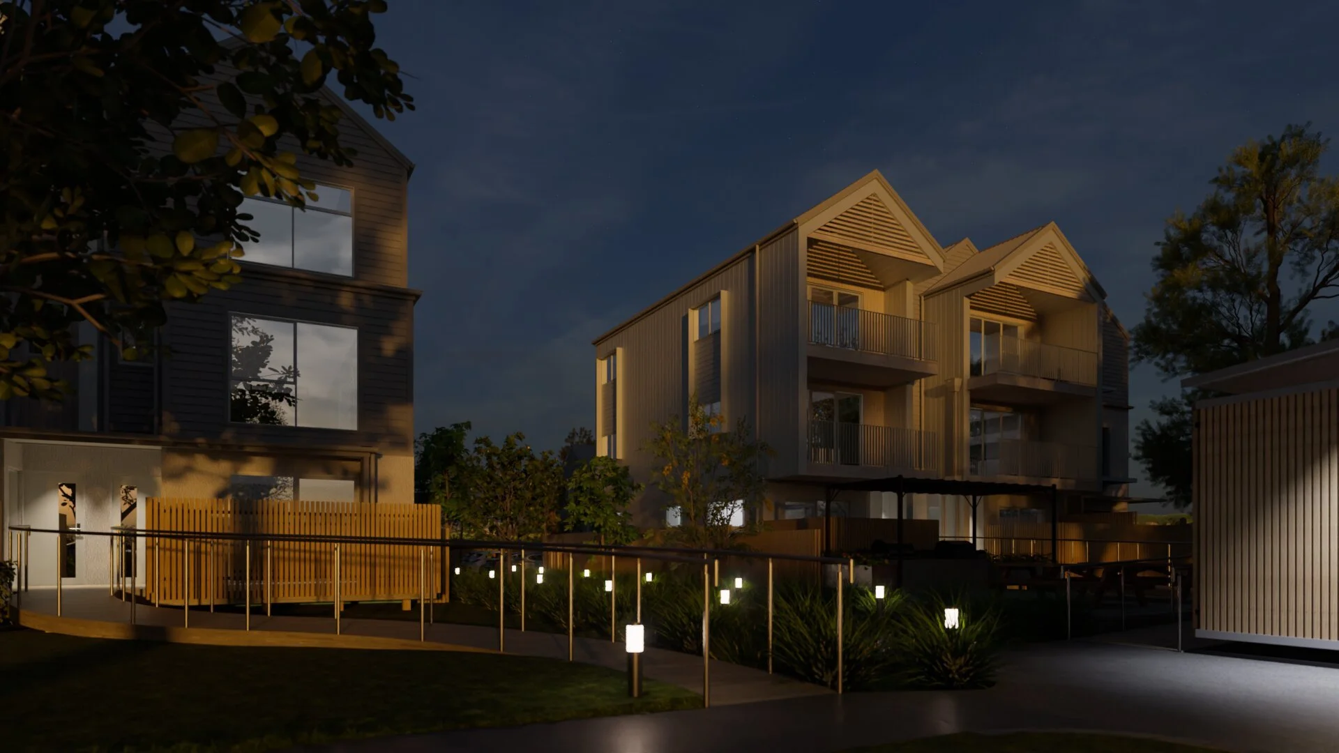 Night view of townhouse development highlighting exterior lighting and shared pathways