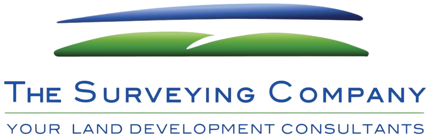 Logo of The Surveying Company with a stylized design in green, blue, black, and yellow, and the tagline "Your Land Development Consultants".