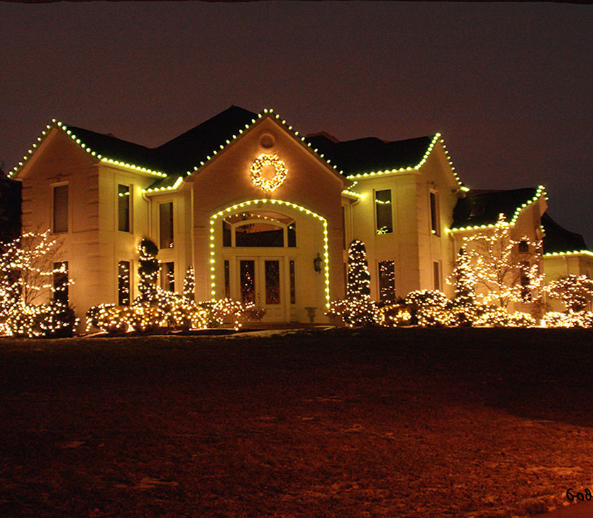 Professional holiday lighting installation on residential home