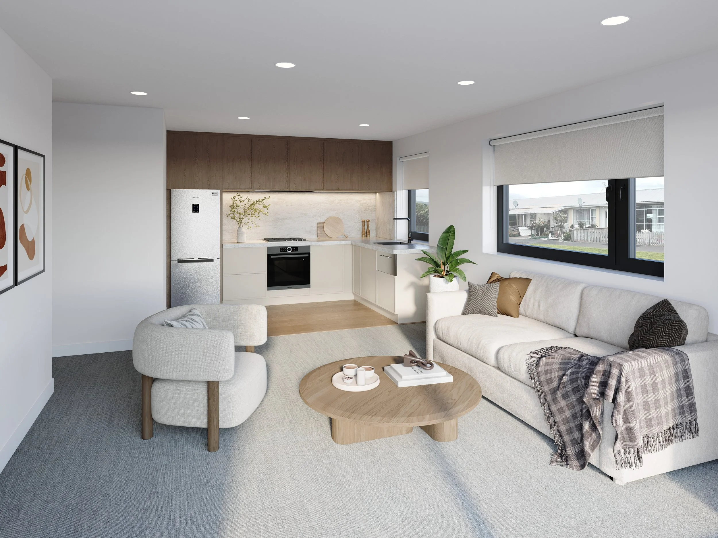 Modern living room with a white sofa, beige armchair, wooden coffee table, and kitchen area with white and wood cabinets, a window with a view of neighboring houses, and decorative plants.