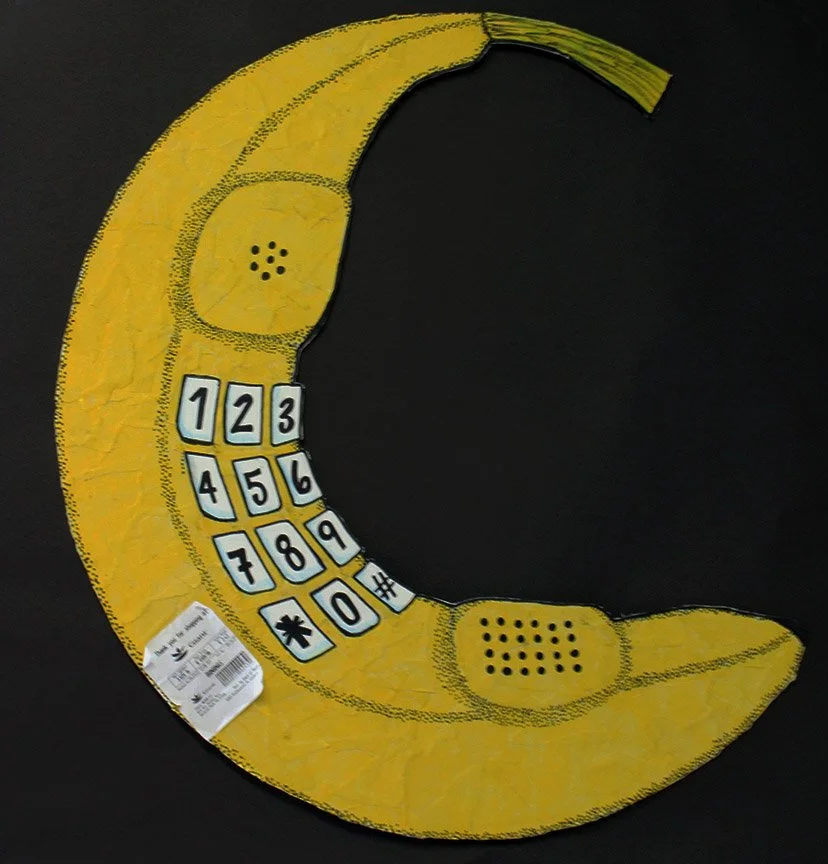 "Anybody There?" is made of constrution paper, sharpie, colored pencils, and a real banana produce sticker. 