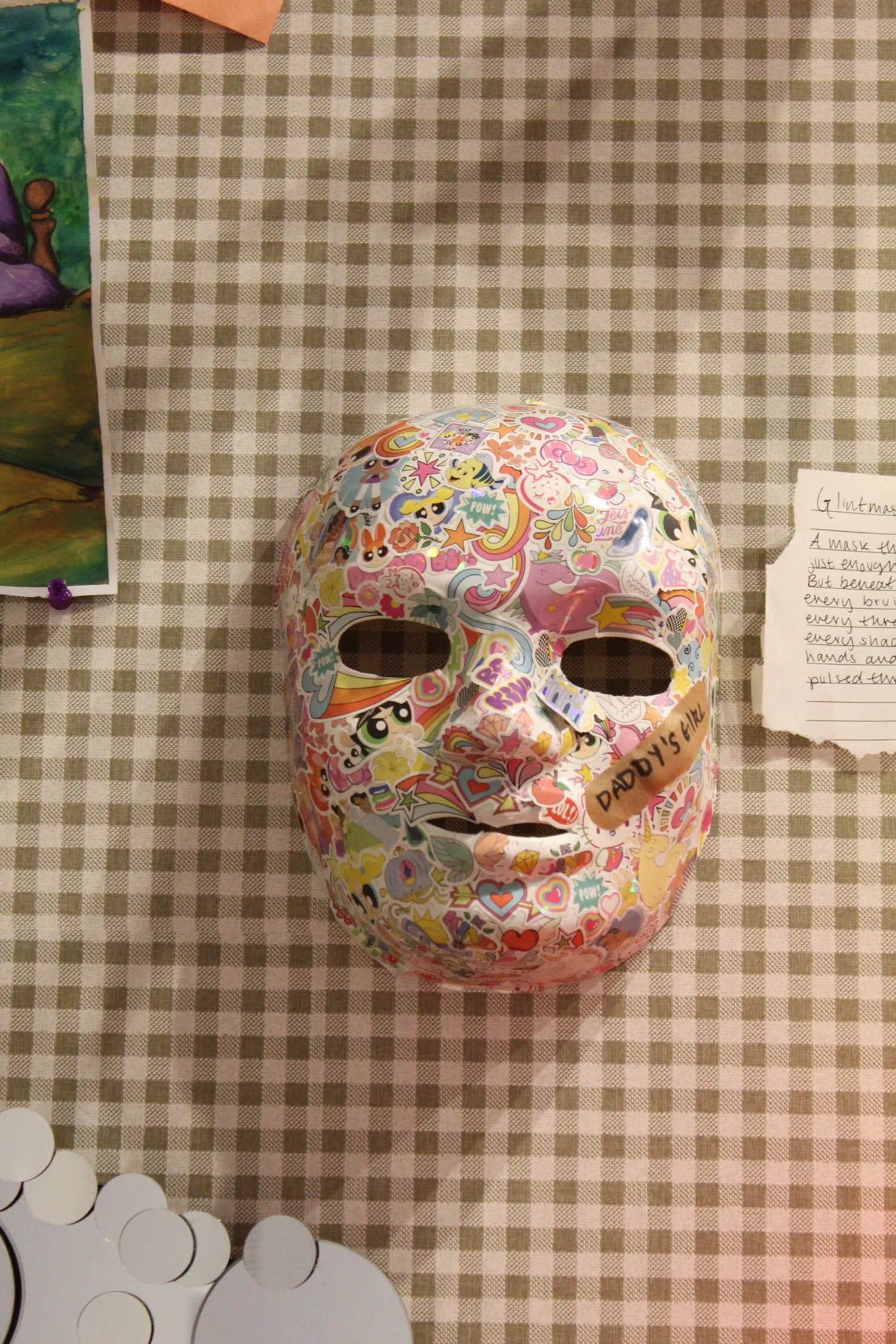 "Glintmask" made with a mask, stickers, and a band-aid.