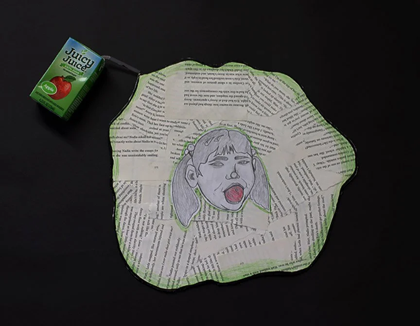 "Puddled thoughts" is made of graphite pencil, charcoal, pages from "Little Women" by Louisa May Alcott, and a real apple juice box.