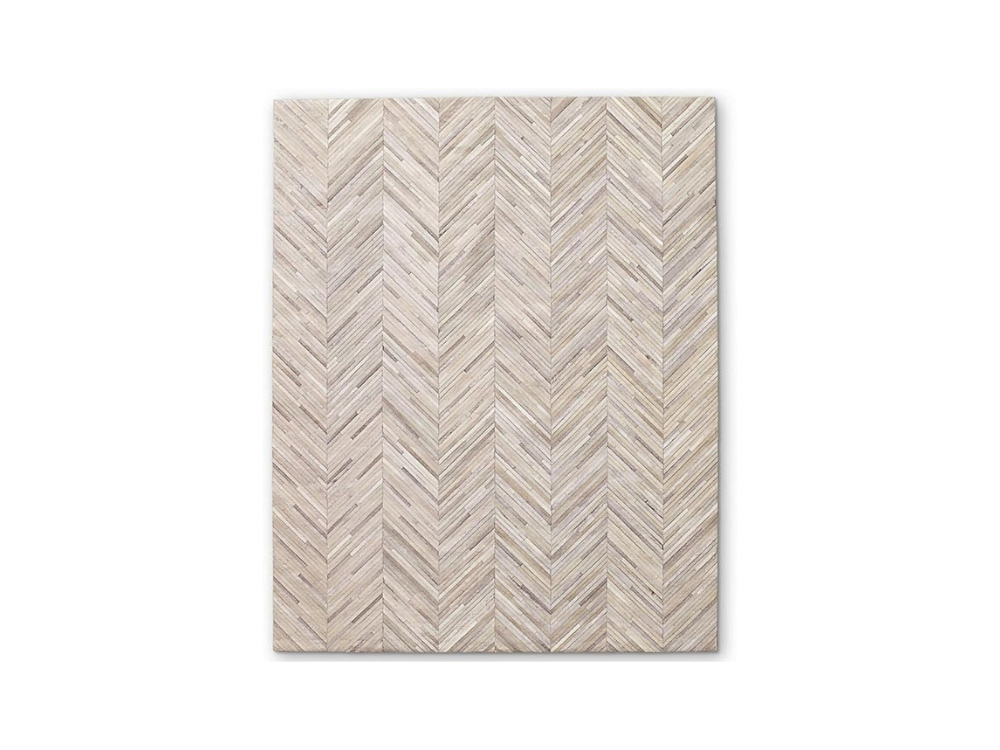 Natural cowhide area rug selected by interior designer for refined spaces