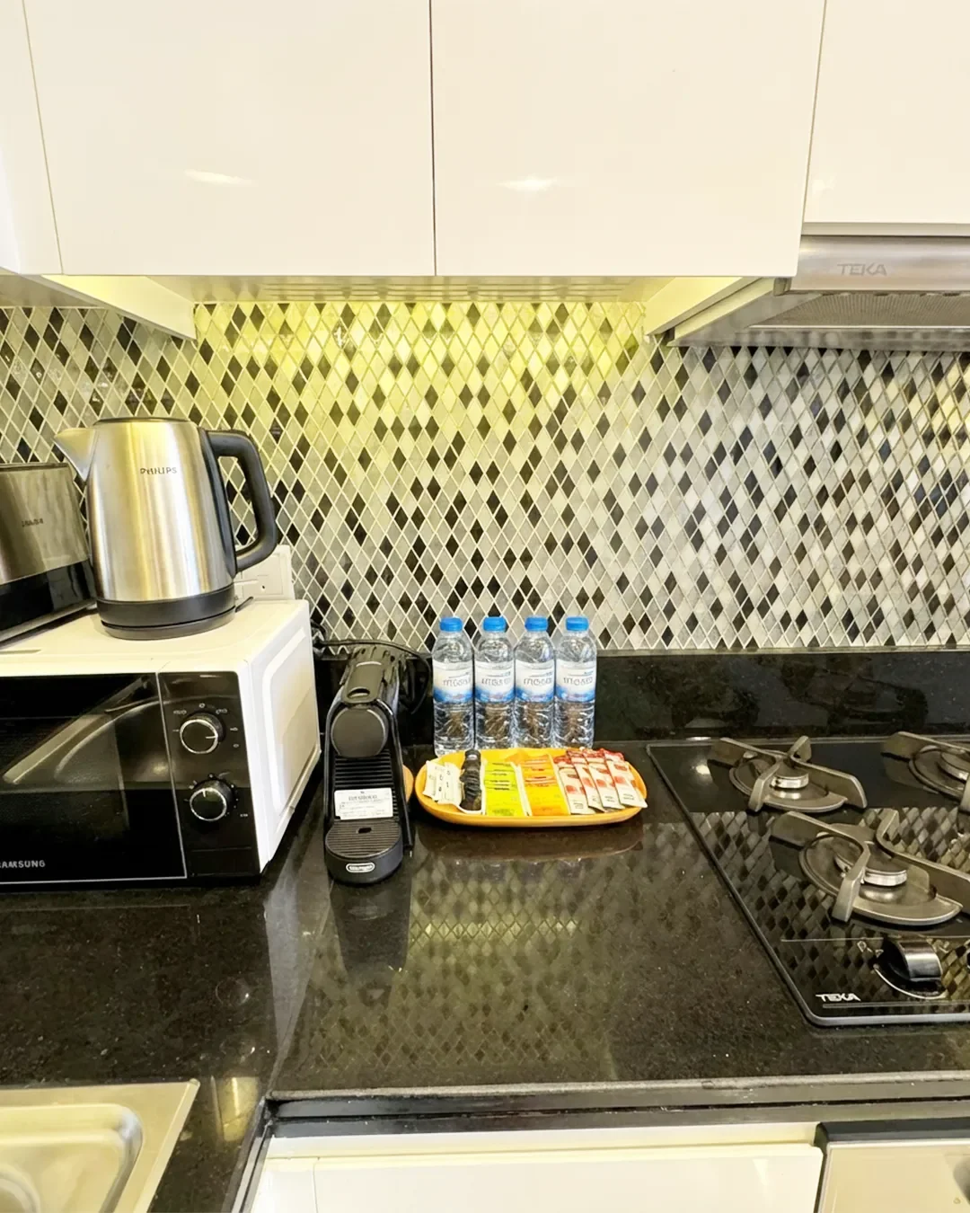 Modern kitchen with clean finishes in fully furnished Business Bay apartment on the 22nd floor.