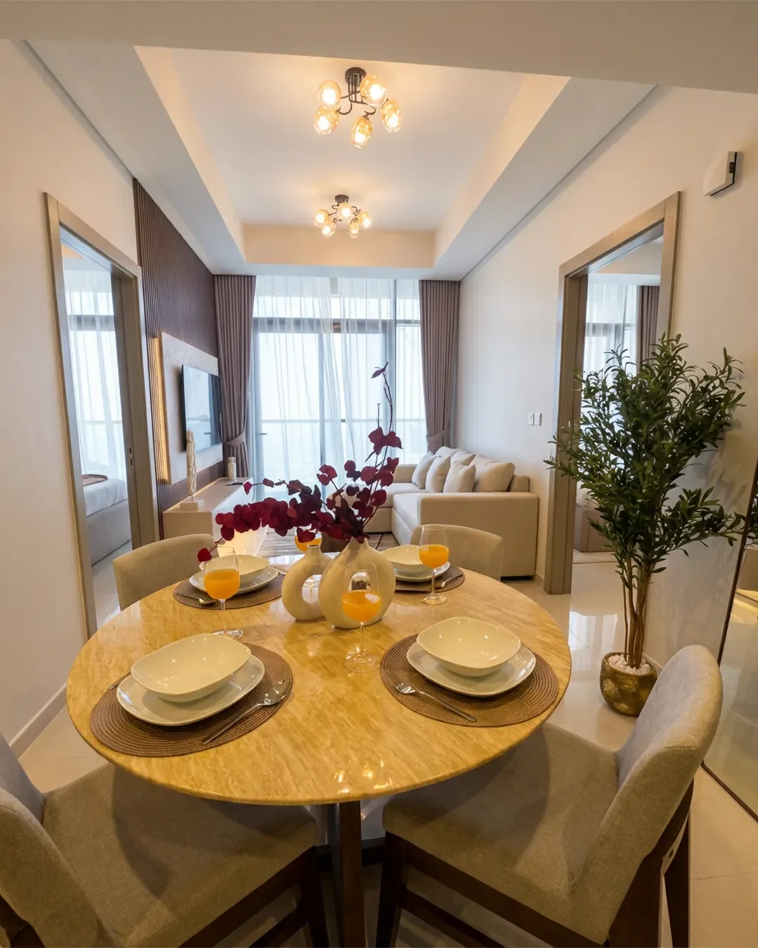 Open-plan dining area with living room in background inside fully furnished Business Bay apartment on the 22nd floor.