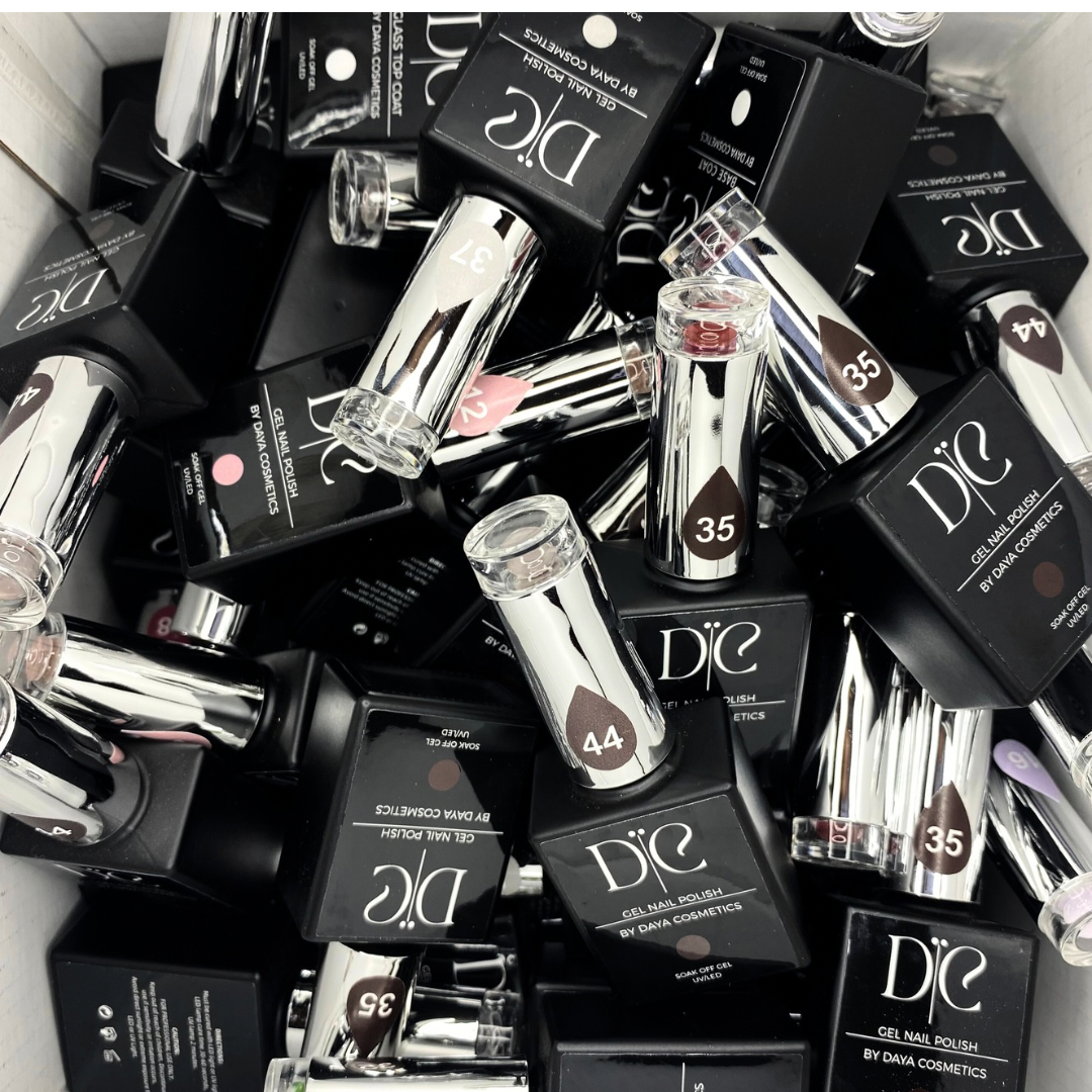 A pile of D'iC gel nail polish bottles in black boxes, with silver caps and labels indicating different shades and numbers.
