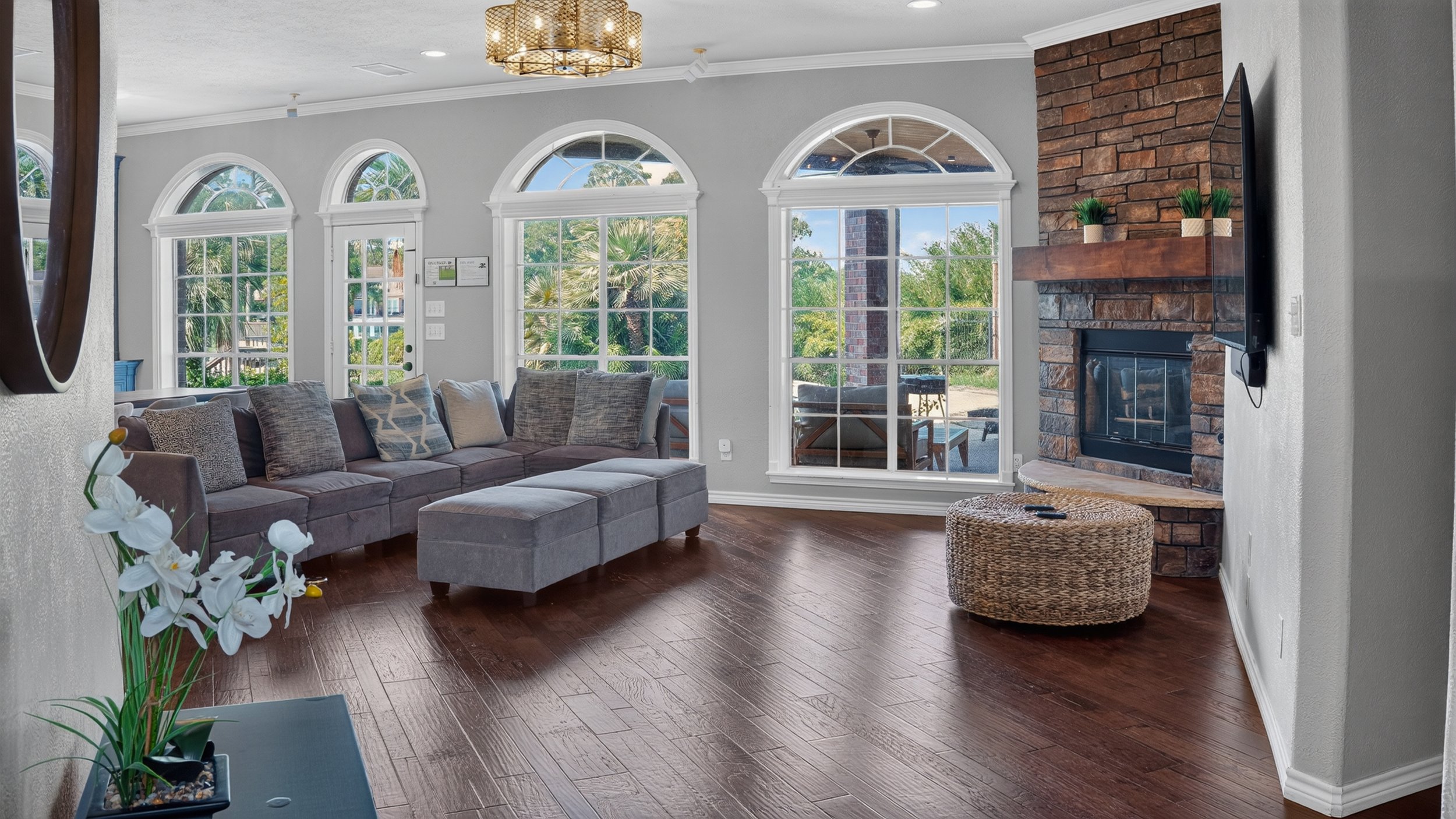 Living room with arched windows and hardwood floors