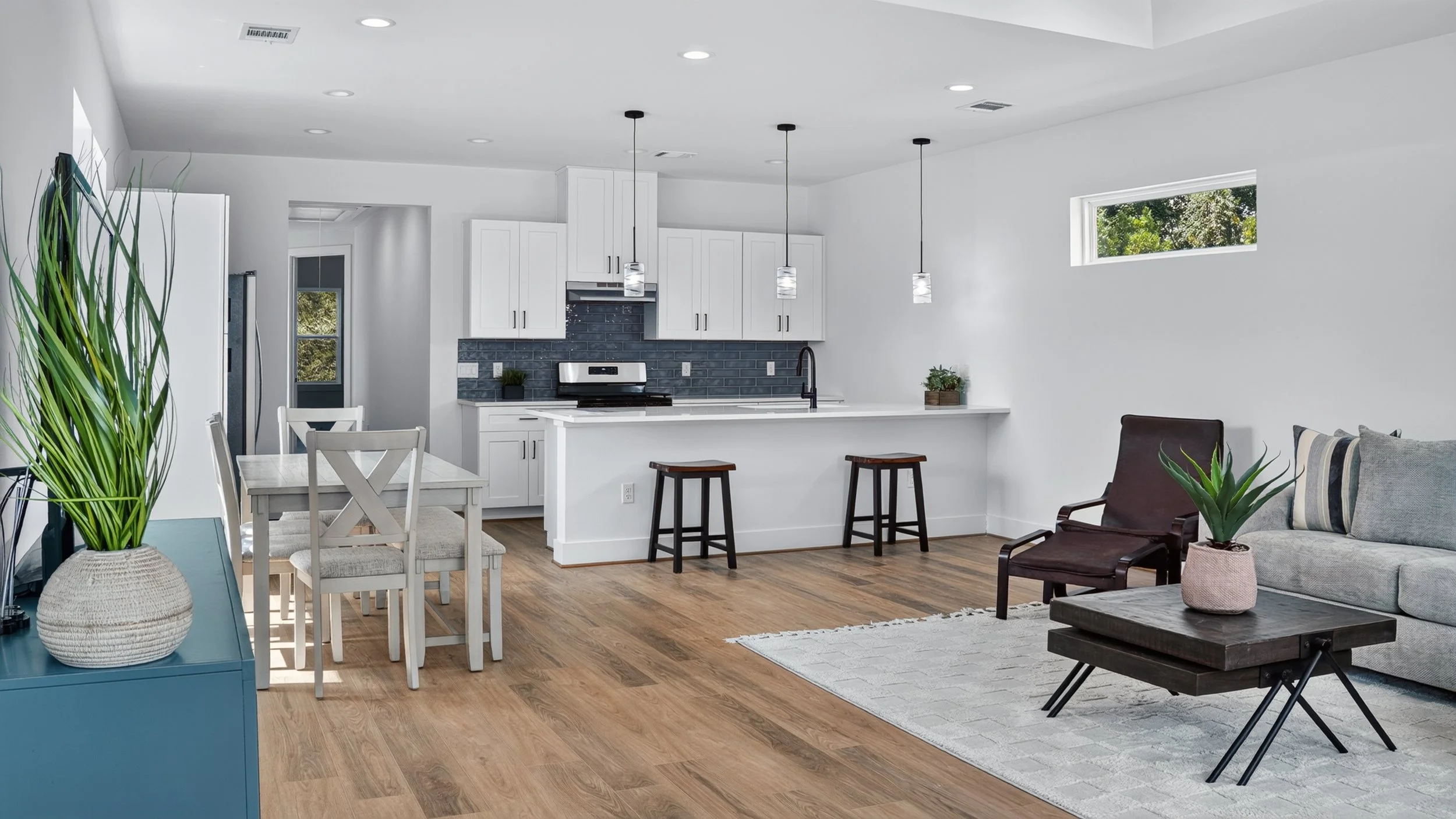Kitchen island with two wood stools, a white countertop, and black faucet