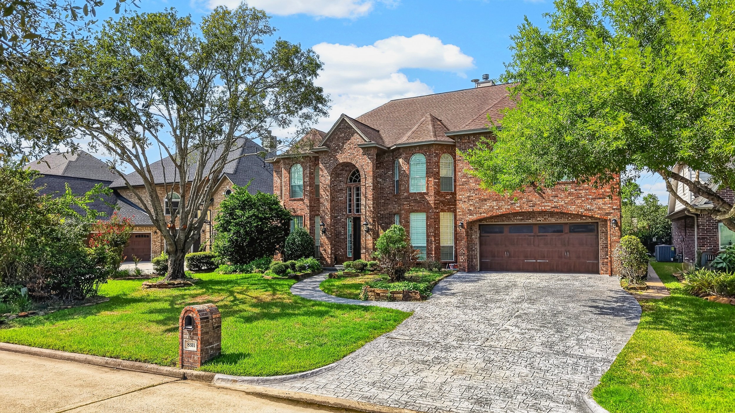 Paver driveway and walkway leading to a brick home in Atascocita, TX