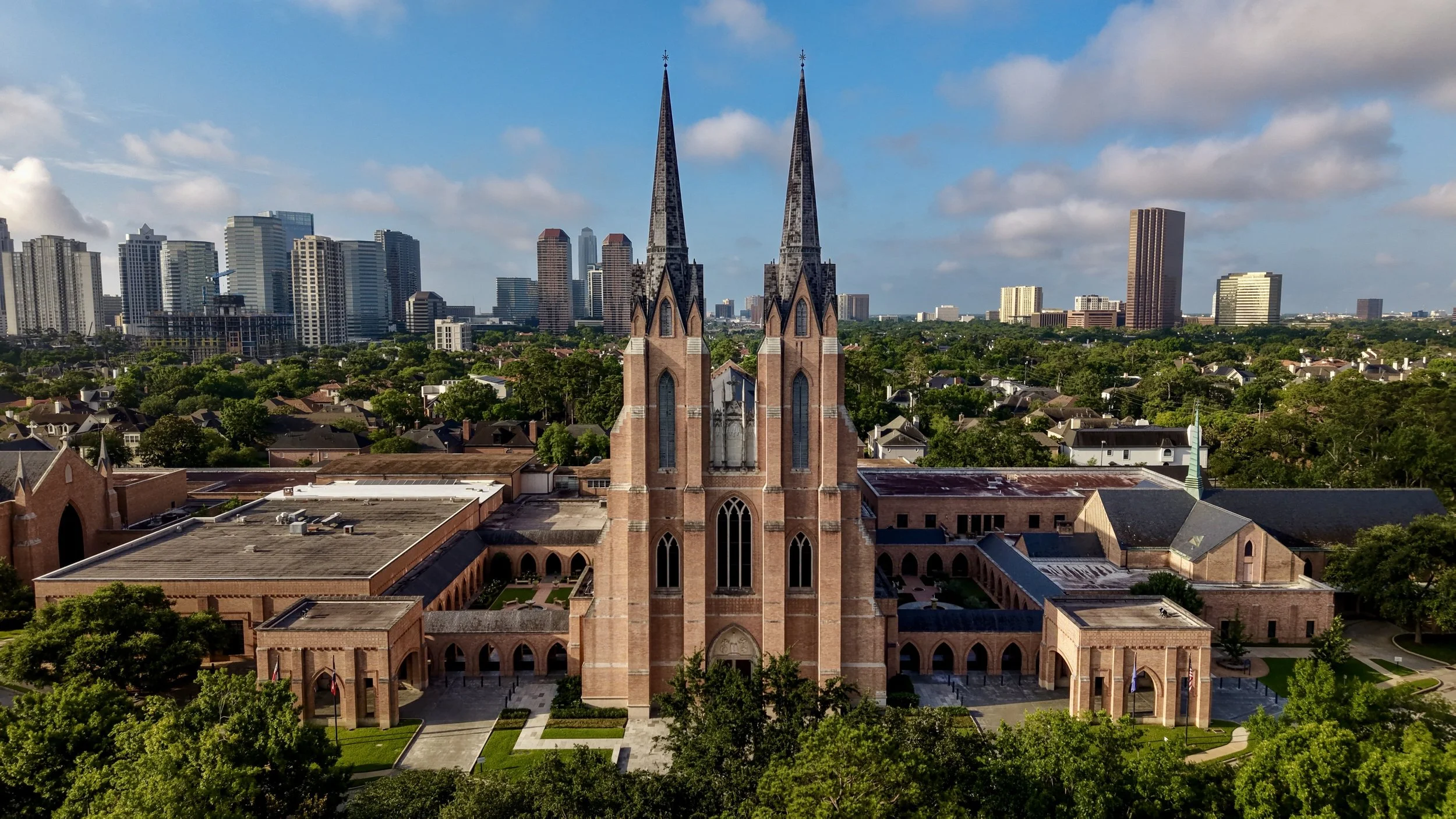 Aerial view of Saint Martin's Episcopal Church with the downtown Houston skyline in the background