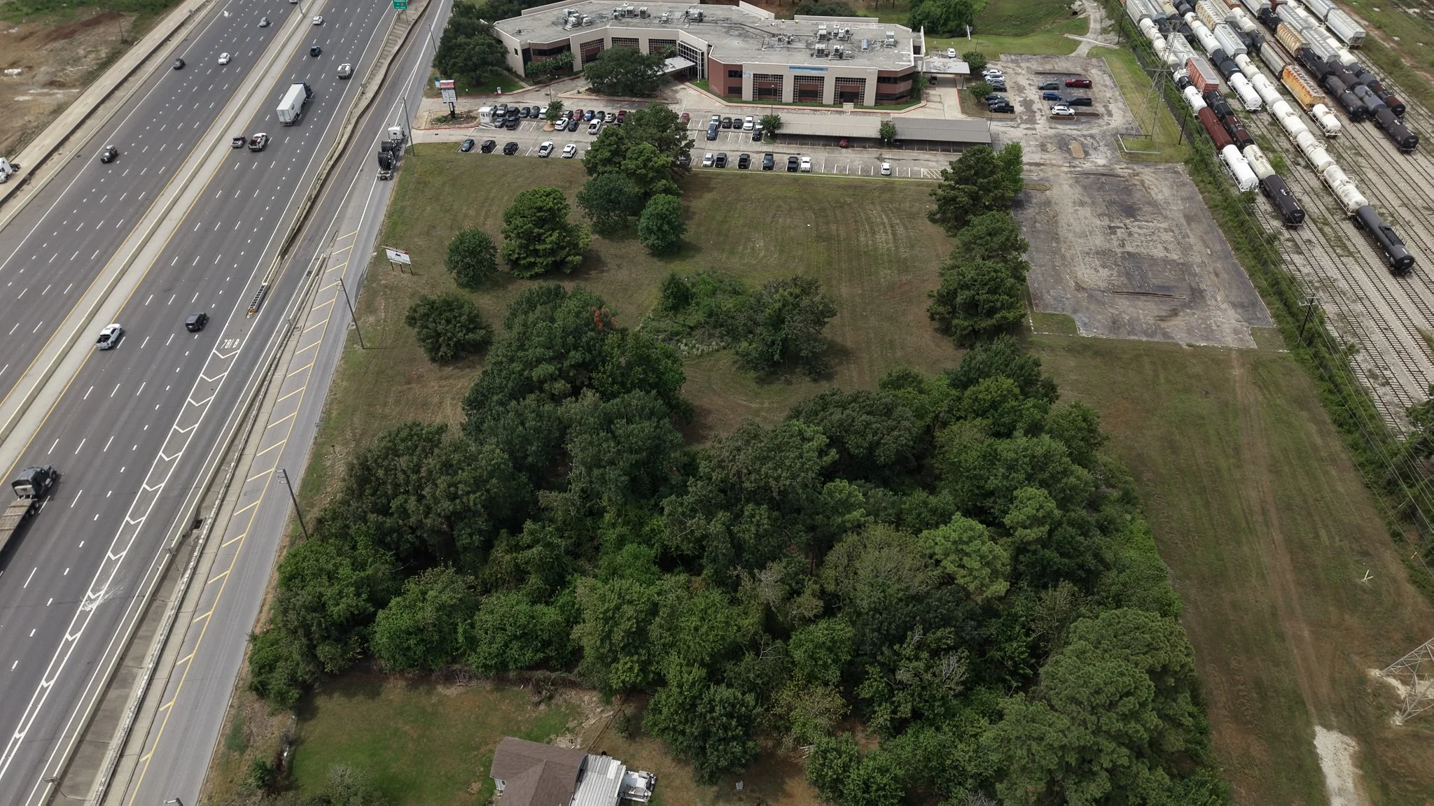 Aerial view of the lot next to an office building and the frontage road
