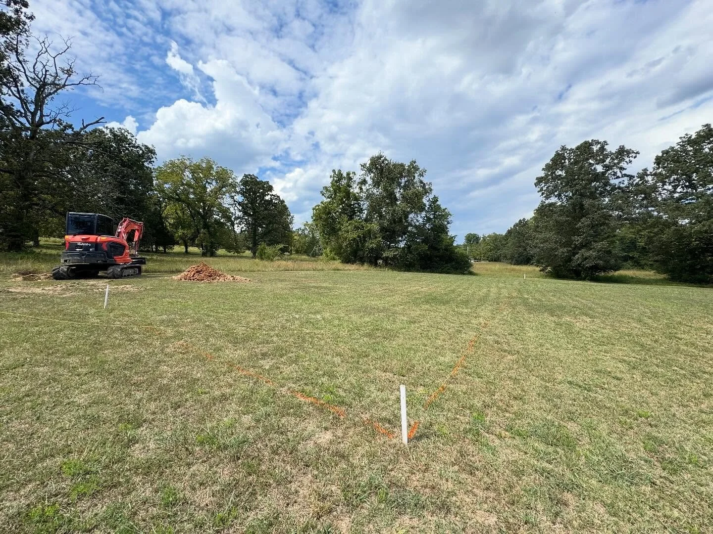 Phase 1
We handled the dig out and prep for a 166 ft concrete retaining wall (4 ft high) and a 100x50 concrete slab &mdash; complete with rebar, heavy wire panels, concrete footings, and compacted fill.
Built to last, built the Ozark way.

☑️ License