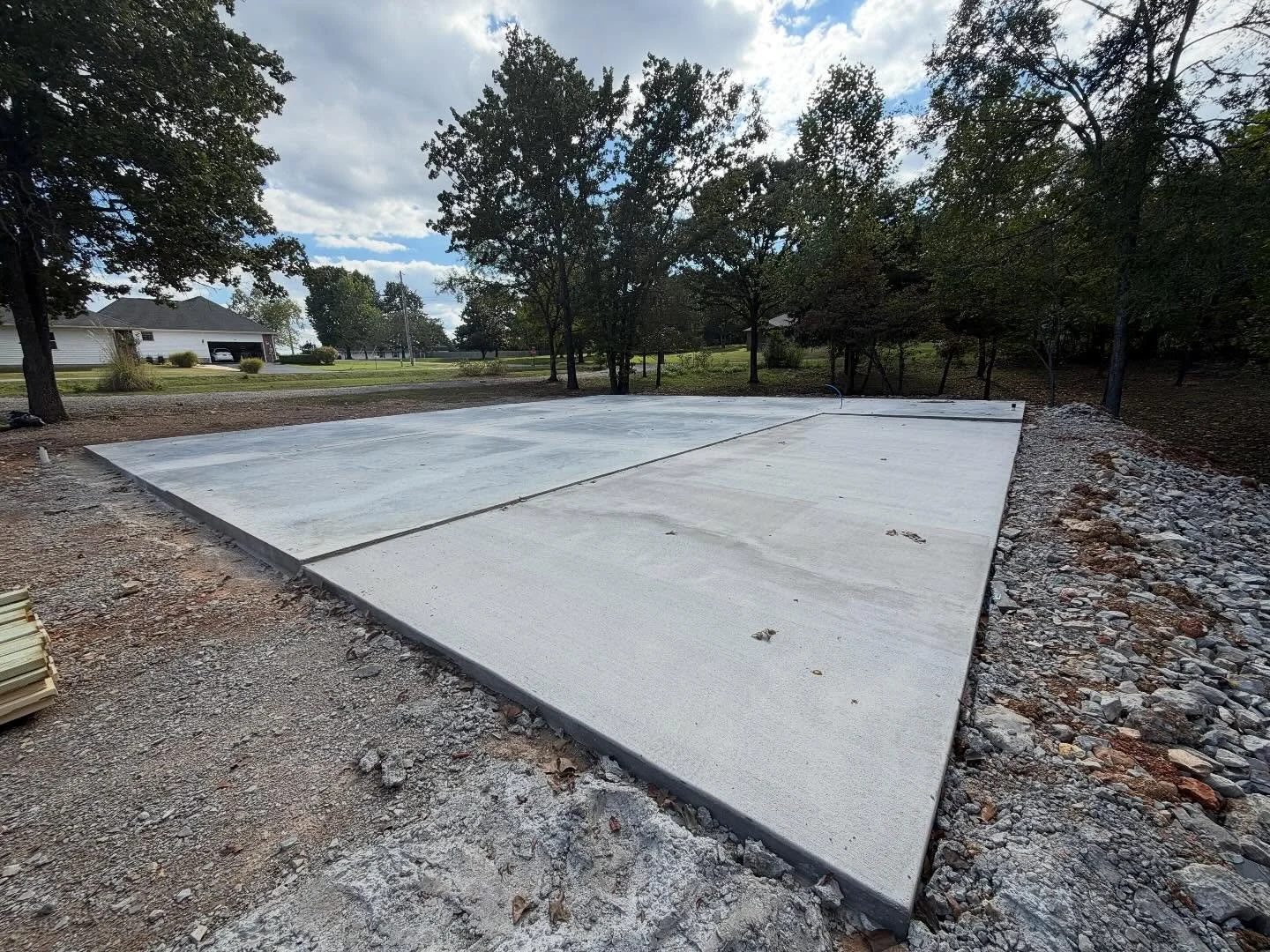 We just completed a 47x50 slab with a back porch. Footings were dug deep and reinforced with rebar, wire mesh was laid with a vapor barrier, and the slab was poured to perfection with a smooth finish.

The back porch was given a durable broom finish 