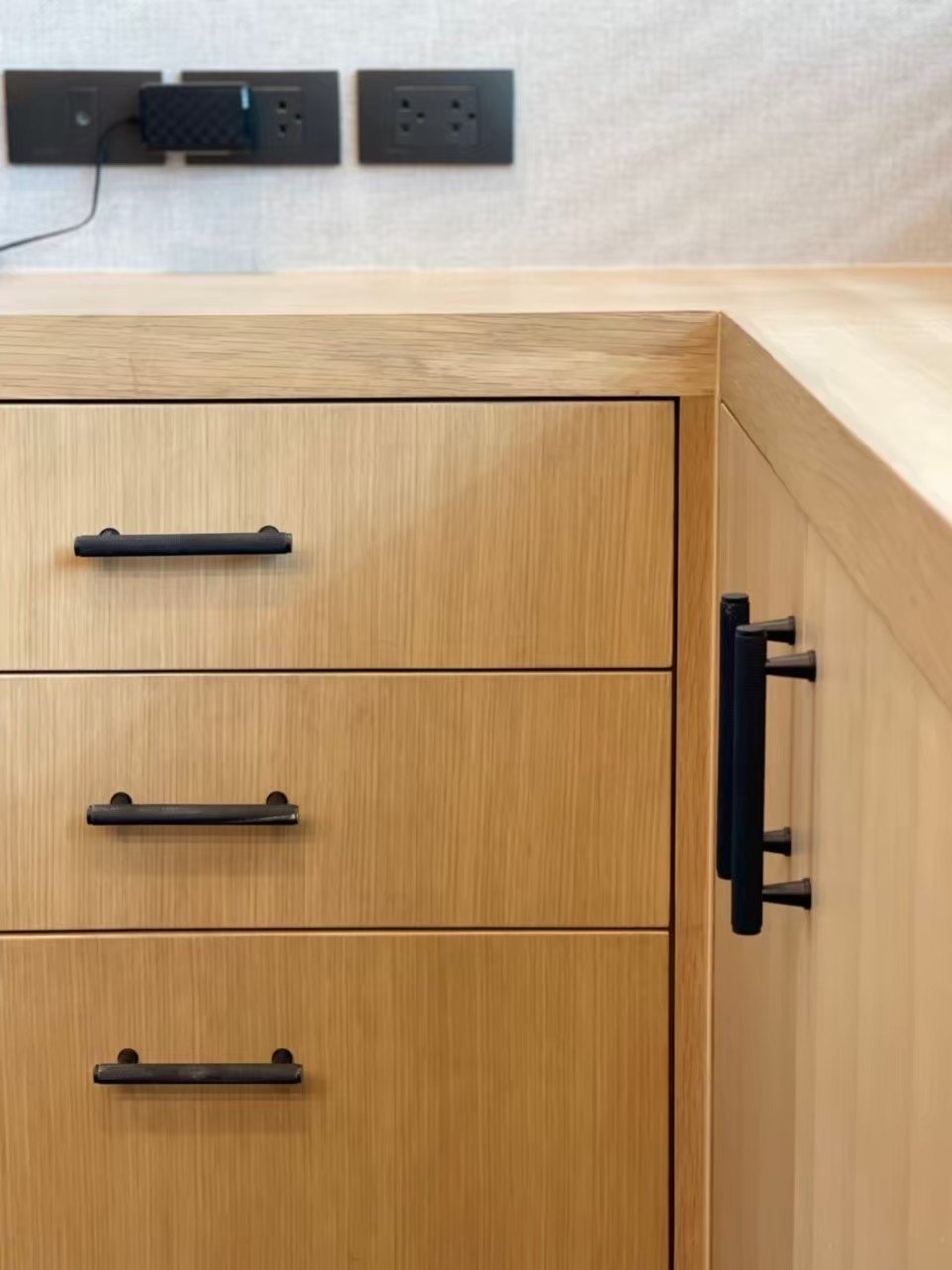 Matte black cabinet handles on custom wooden drawers in private residence – Before Closet