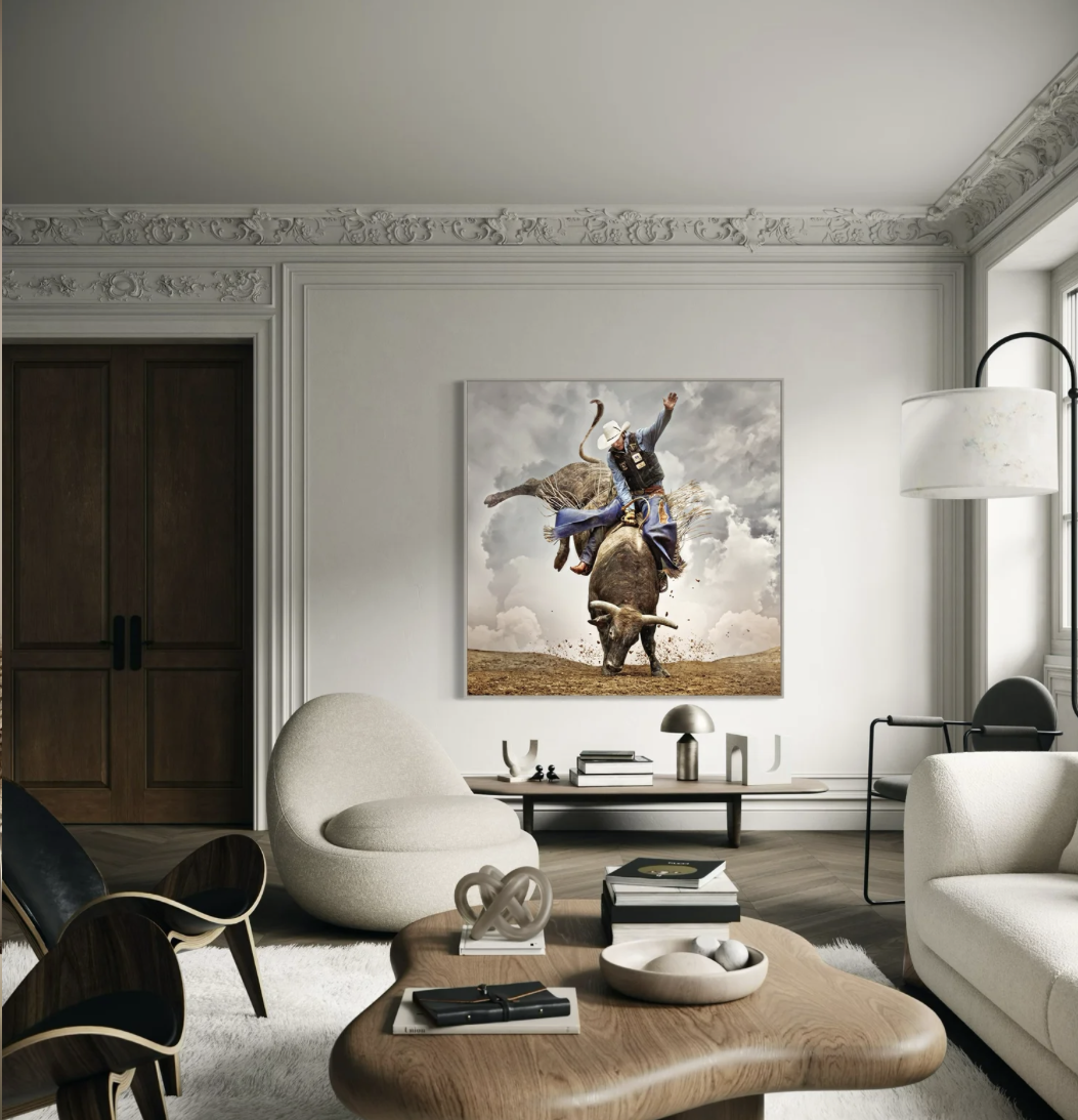 Living room with modern furniture and a large painting of a cowboy riding a buffalo on the wall.