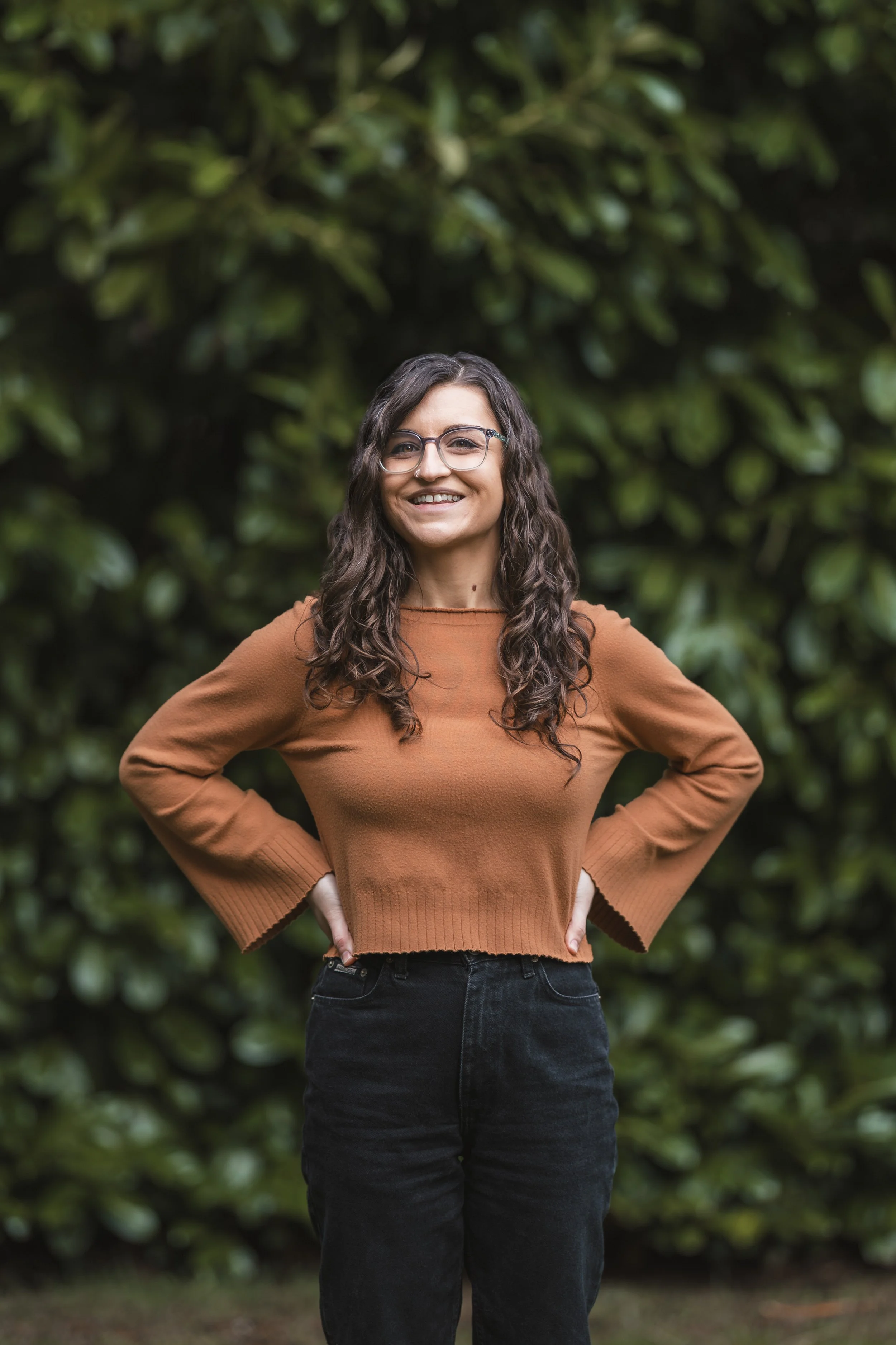 woman standing and smiling with hands on waist