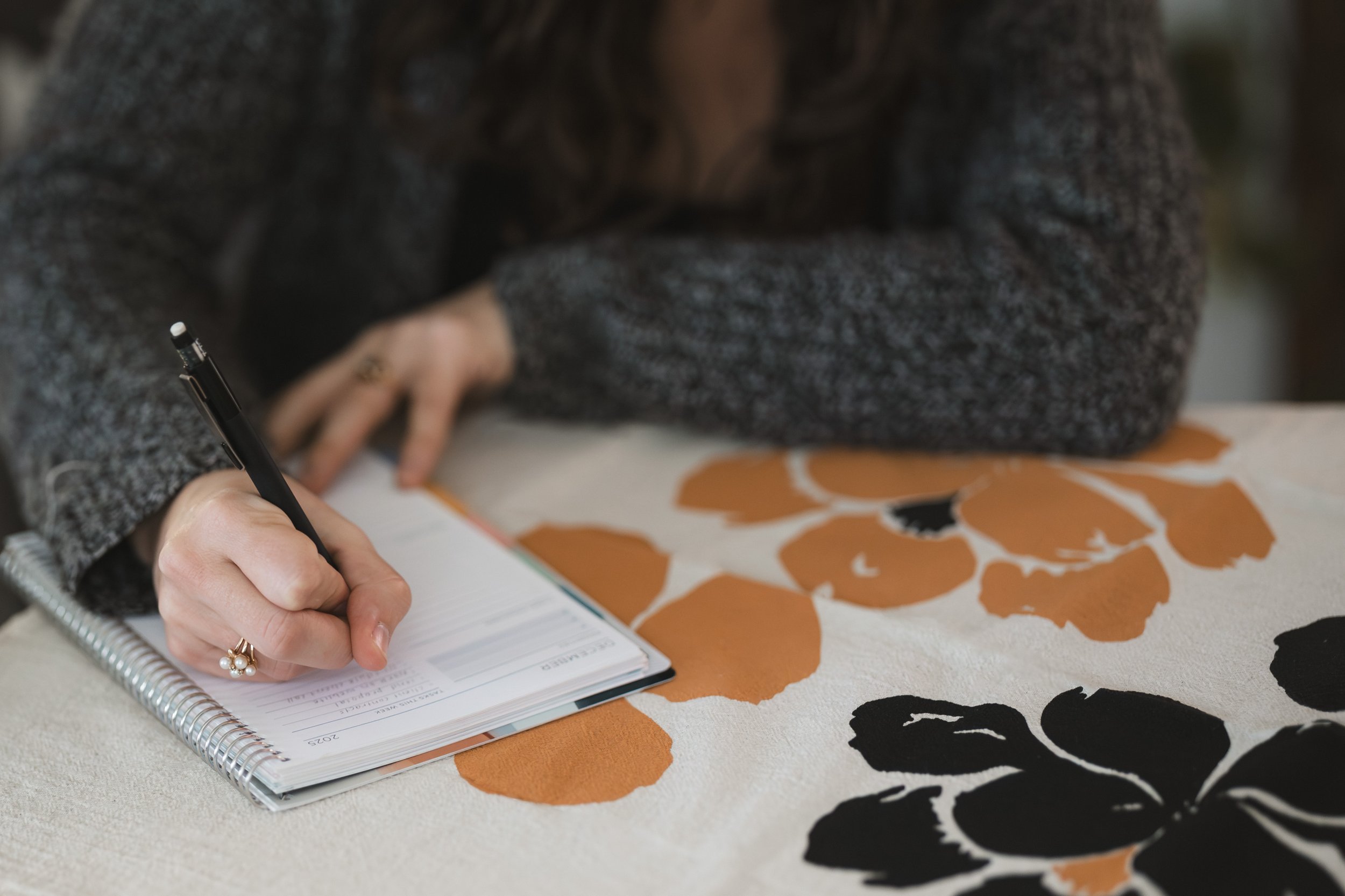 woman writing in planner