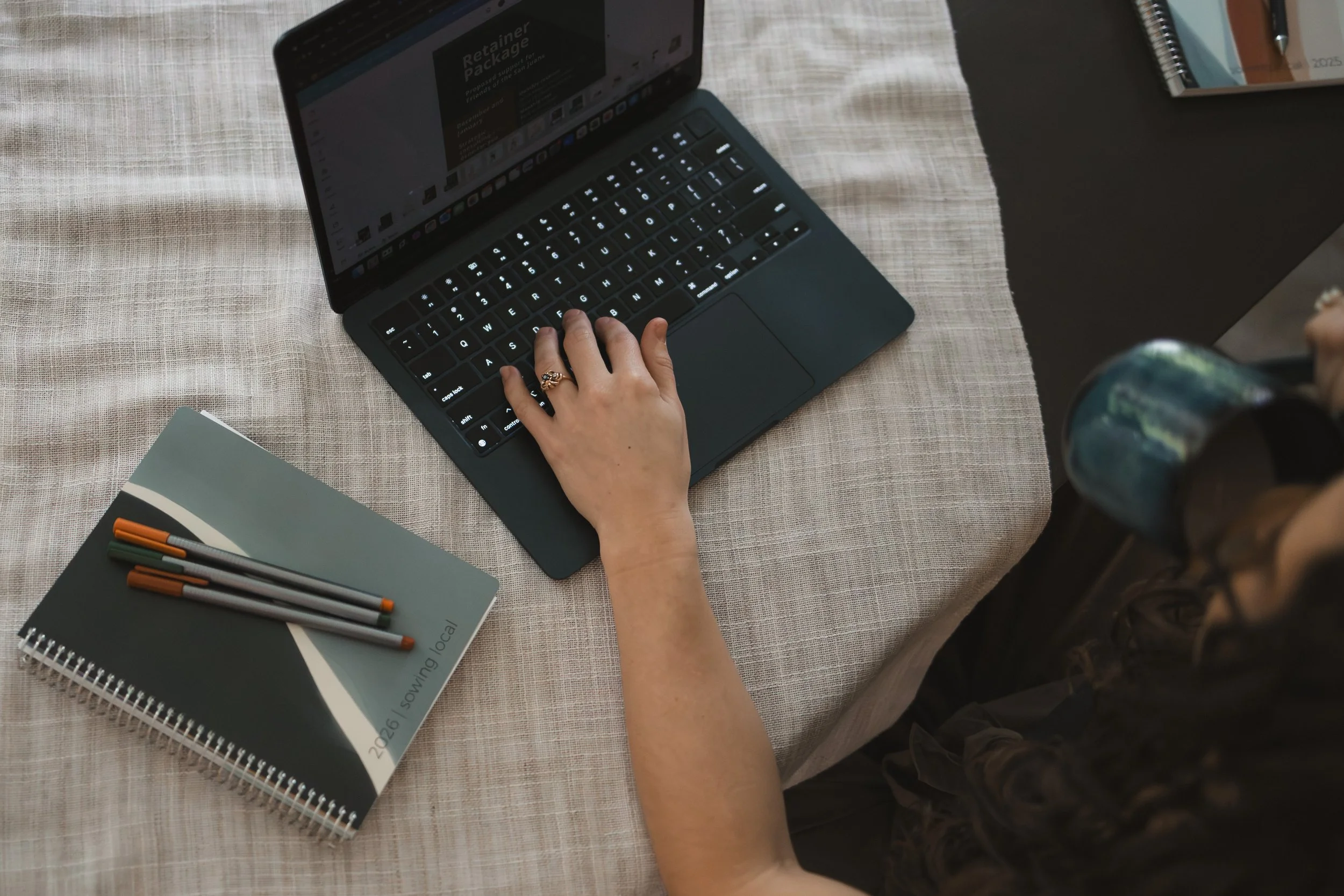 woman working at laptop and sipping from mug