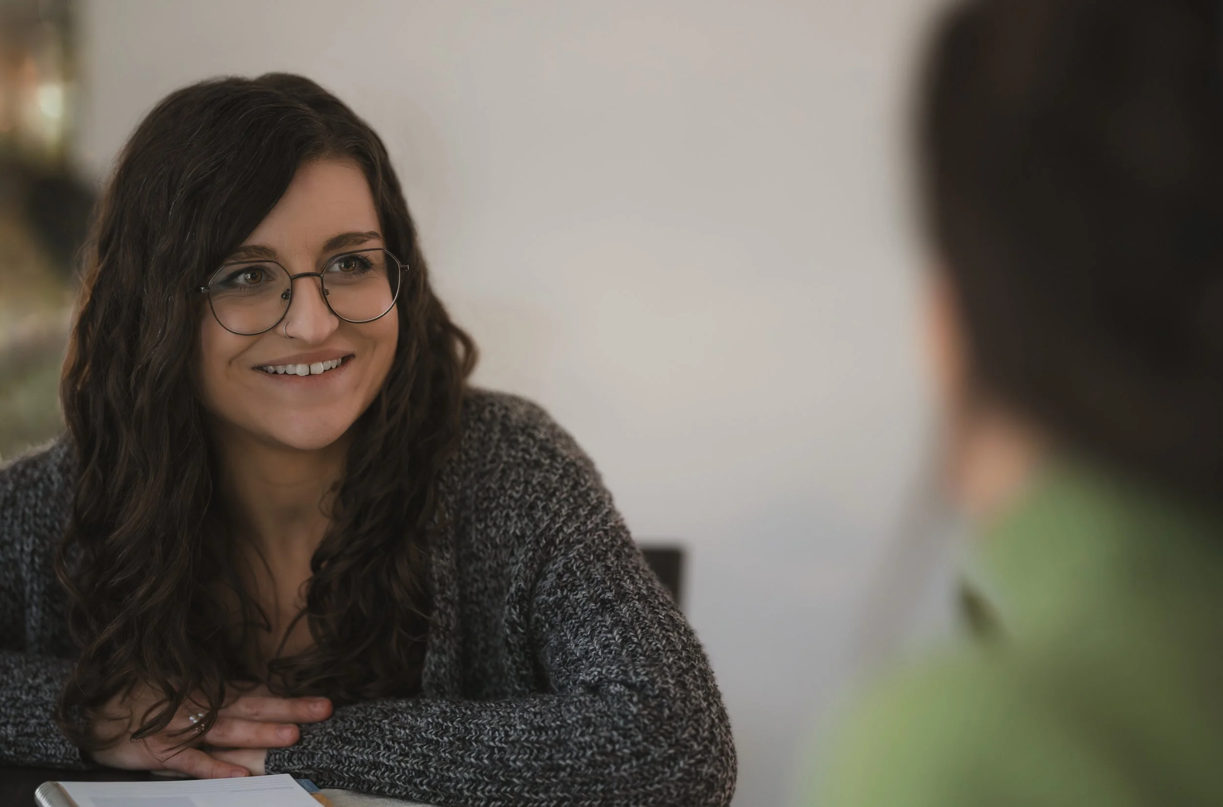 woman smiling while meeting with a client