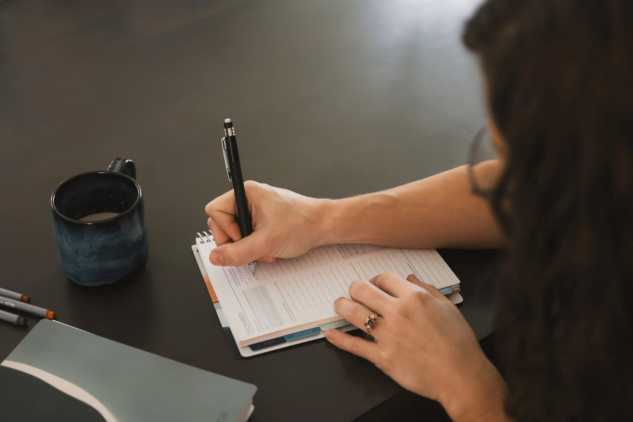 woman writing in planner
