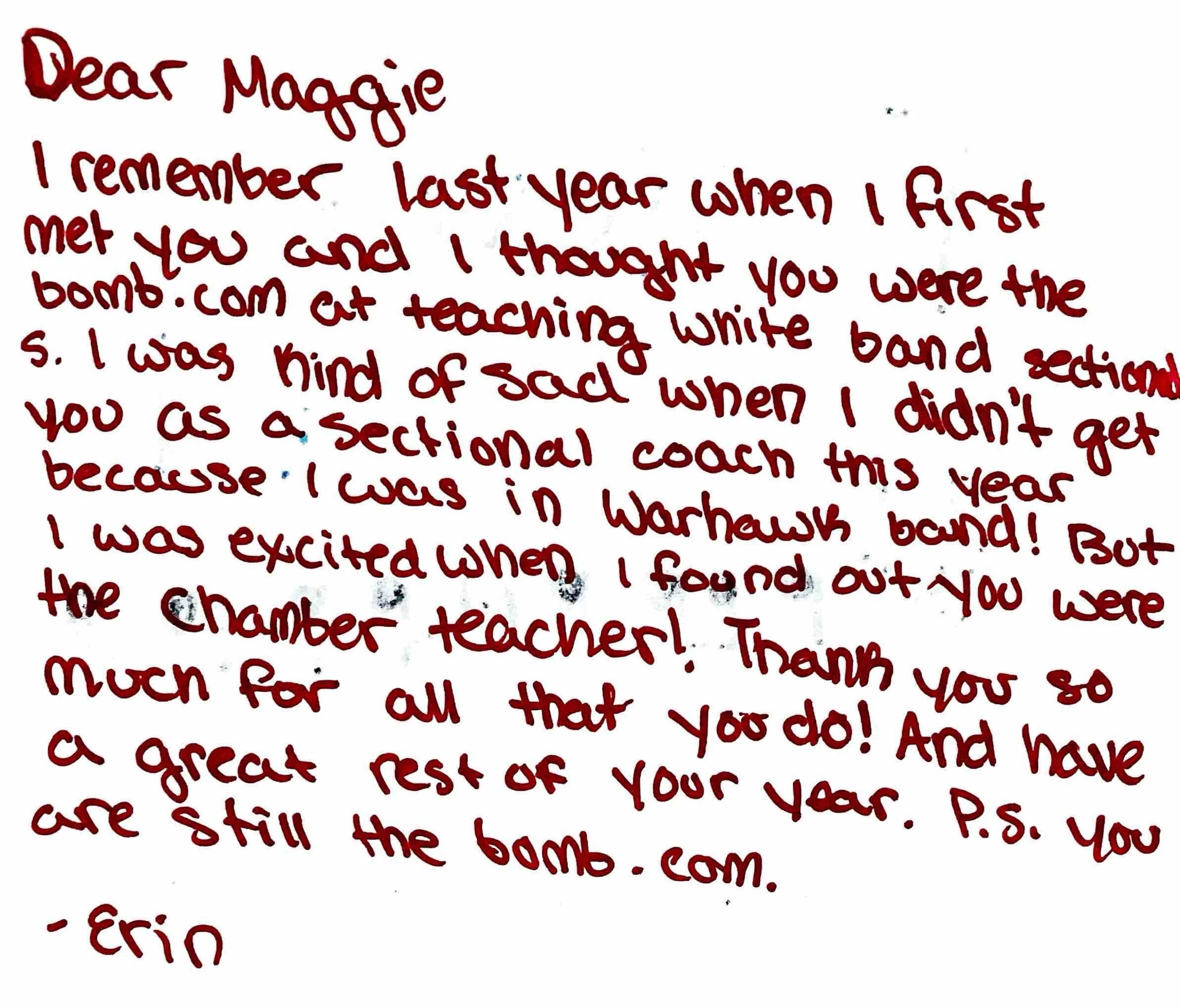 Handwritten note in red ink about meeting Maggie last year and teaching a white band section in a theater. The note is written on white paper with some text extending beyond the visible area.