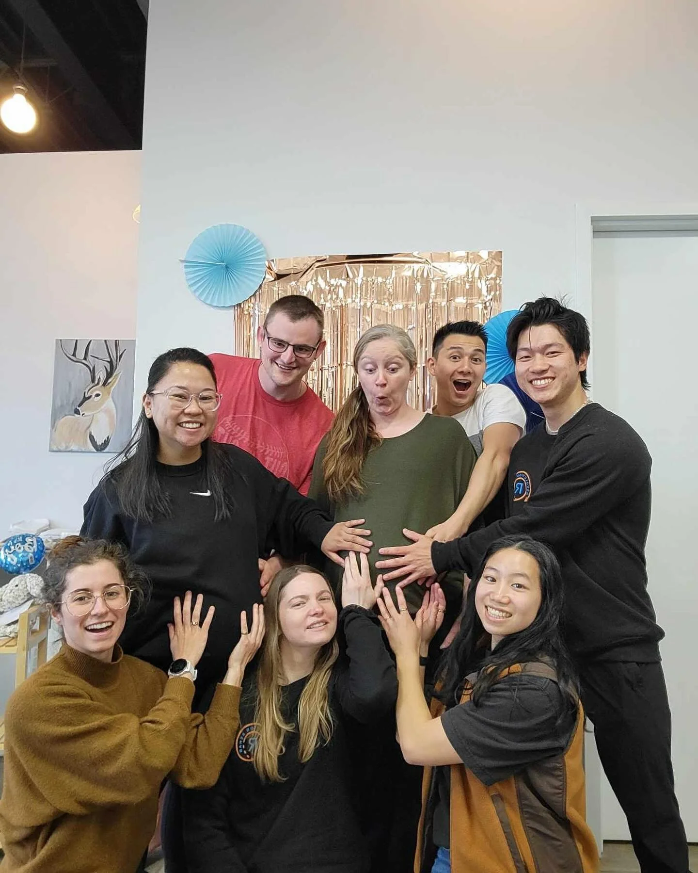 The revolution team touching Alecs and Nikki's pregnant bellies.