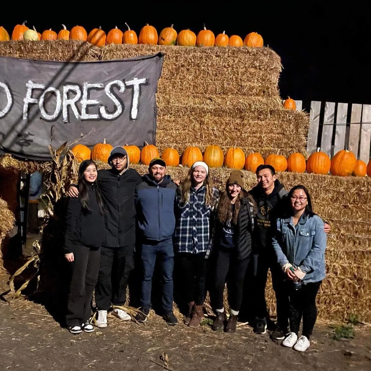 The Revolution team in front of hay stacks