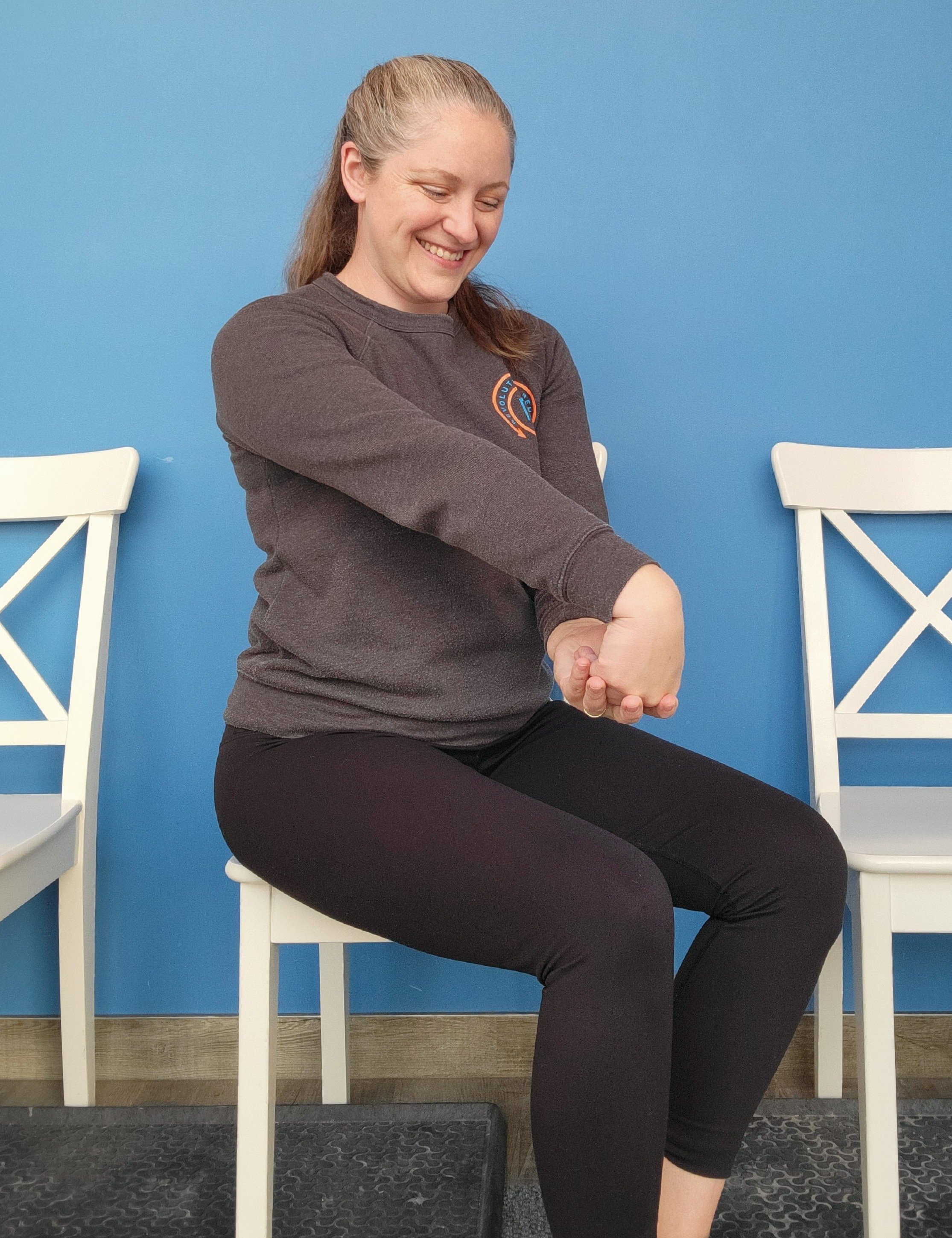 Athletic Therapist, Nikki Smith, showing a forearm extensor stretch to help with lateral epicondylitis or tennis elbow.