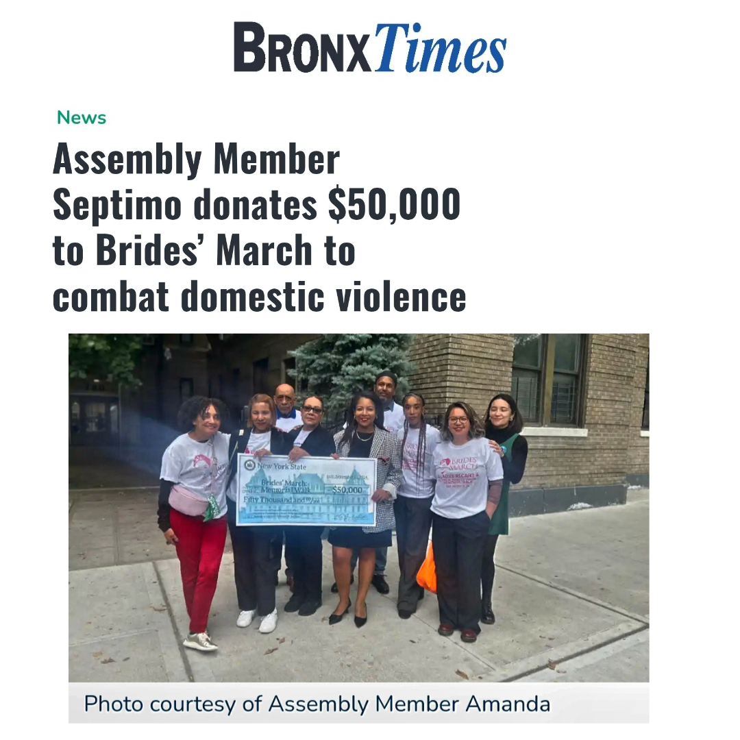 A group of people holding a large check for $50,000 outside a brick building. The image is part of a Bronx Times article about Assembly Member Septimo donating to the Brides' March to fight domestic violence.